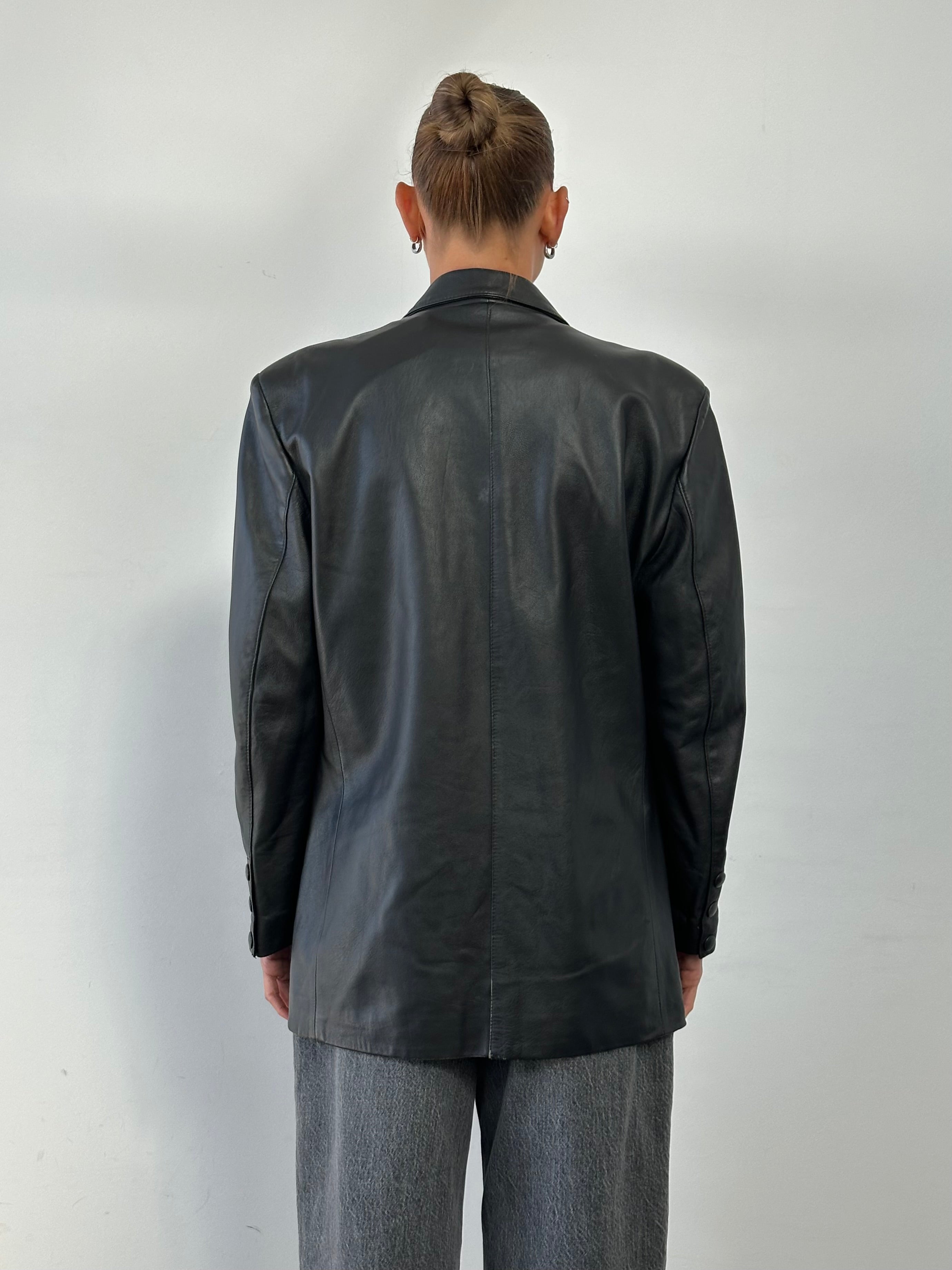 Vintage double-breasted leather blazer jacket in size large, featuring classic design and tailored fit.