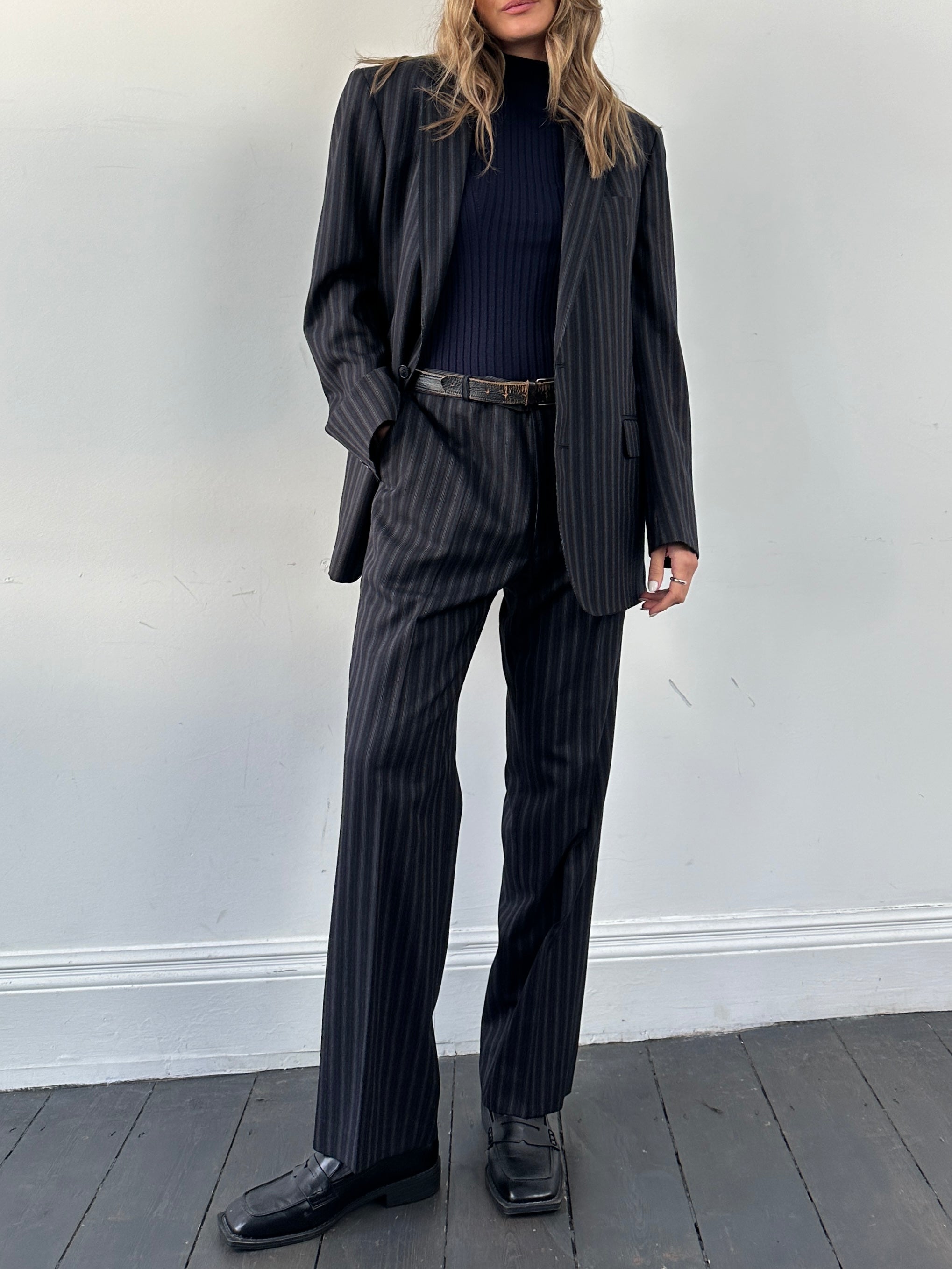 Christian Dior wool pinstripe jumpsuit in size 42L/W34, featuring tailored pinstripe fabric and classic suit style.