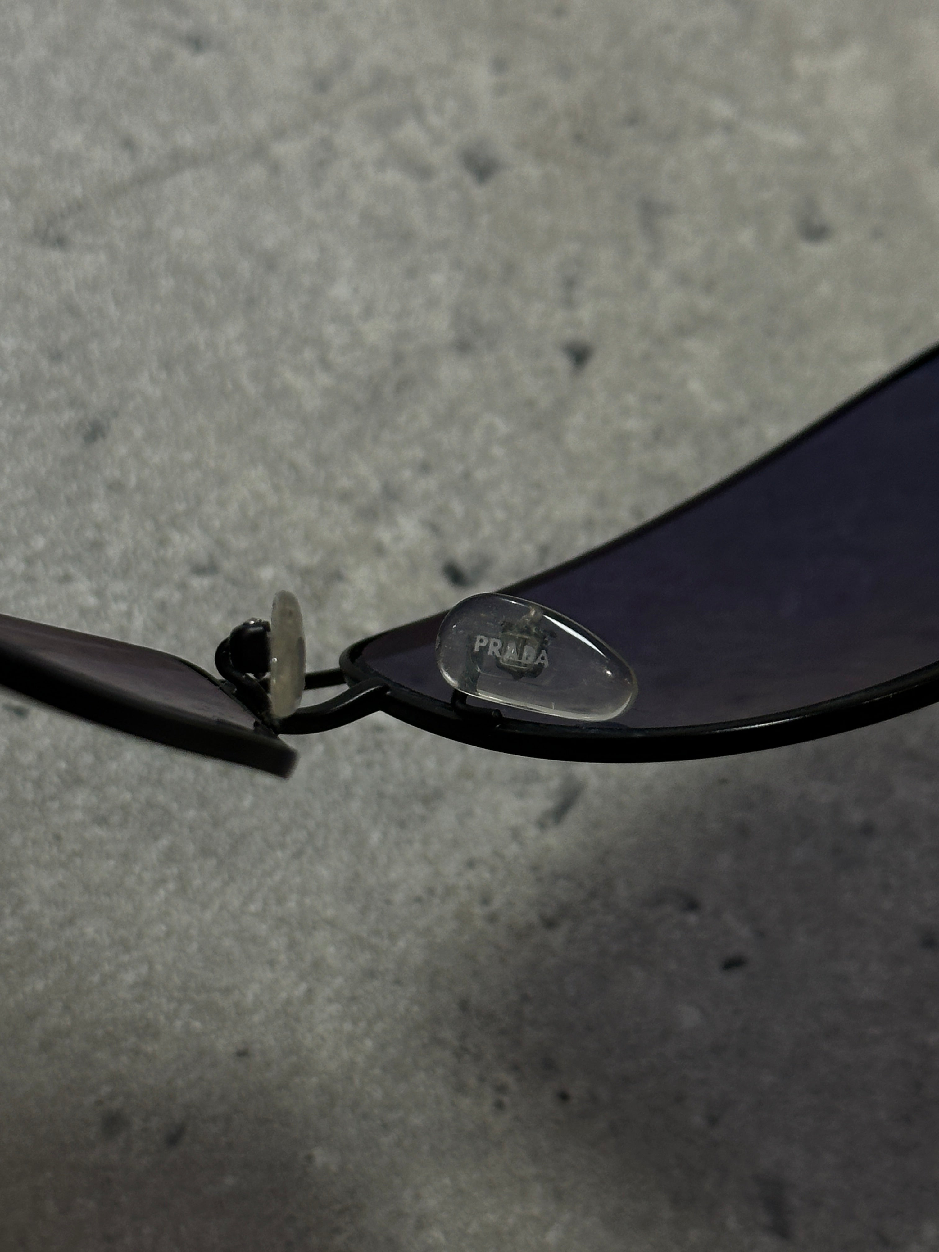 Prada aviator shield sunglasses with dark tinted lenses and metal frame, stylish and protective eyewear for sun protection.