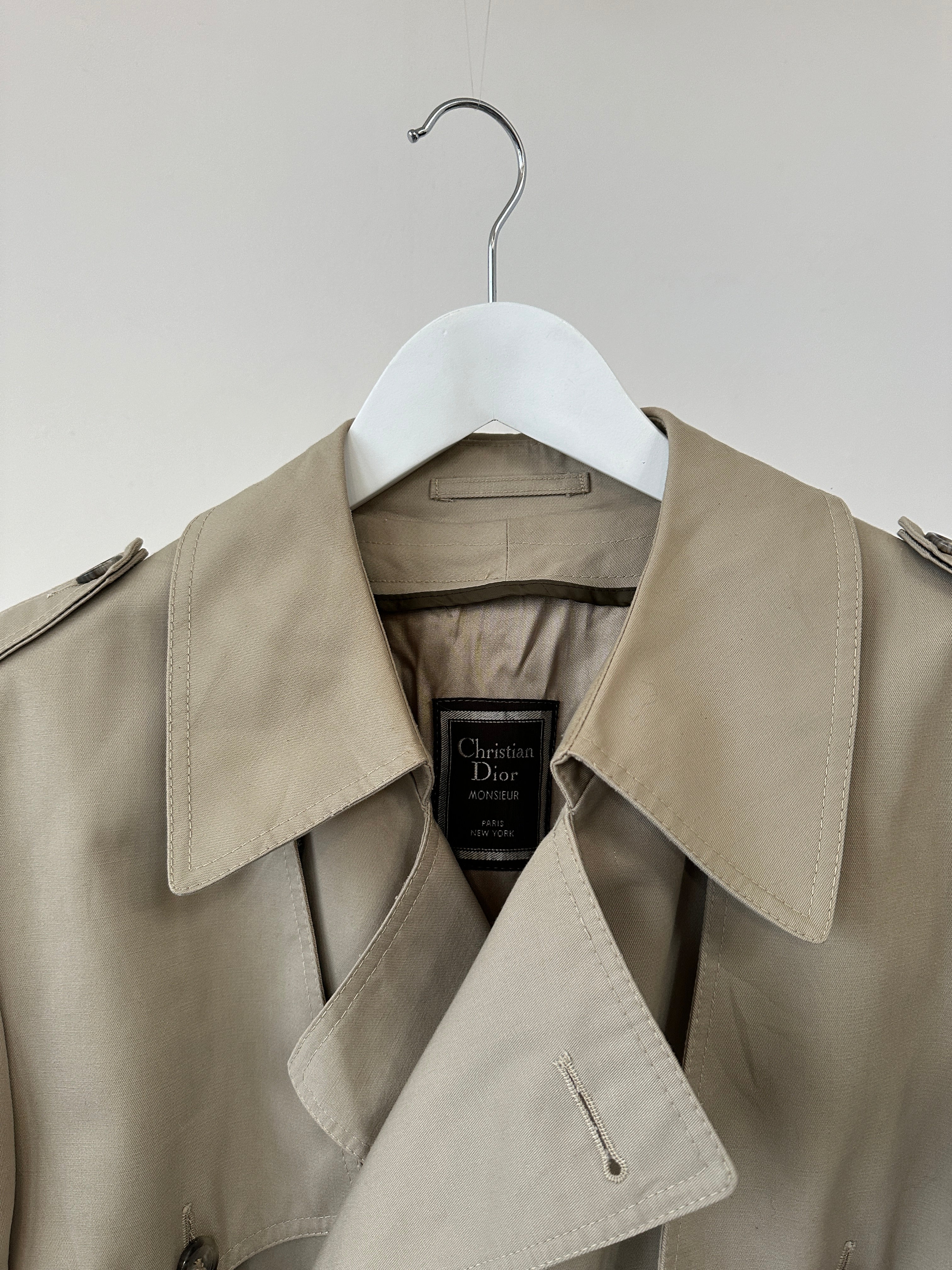 Christian Dior double-breasted belted trench coat in XL, featuring classic design and tailored fit, shown on a neutral background.