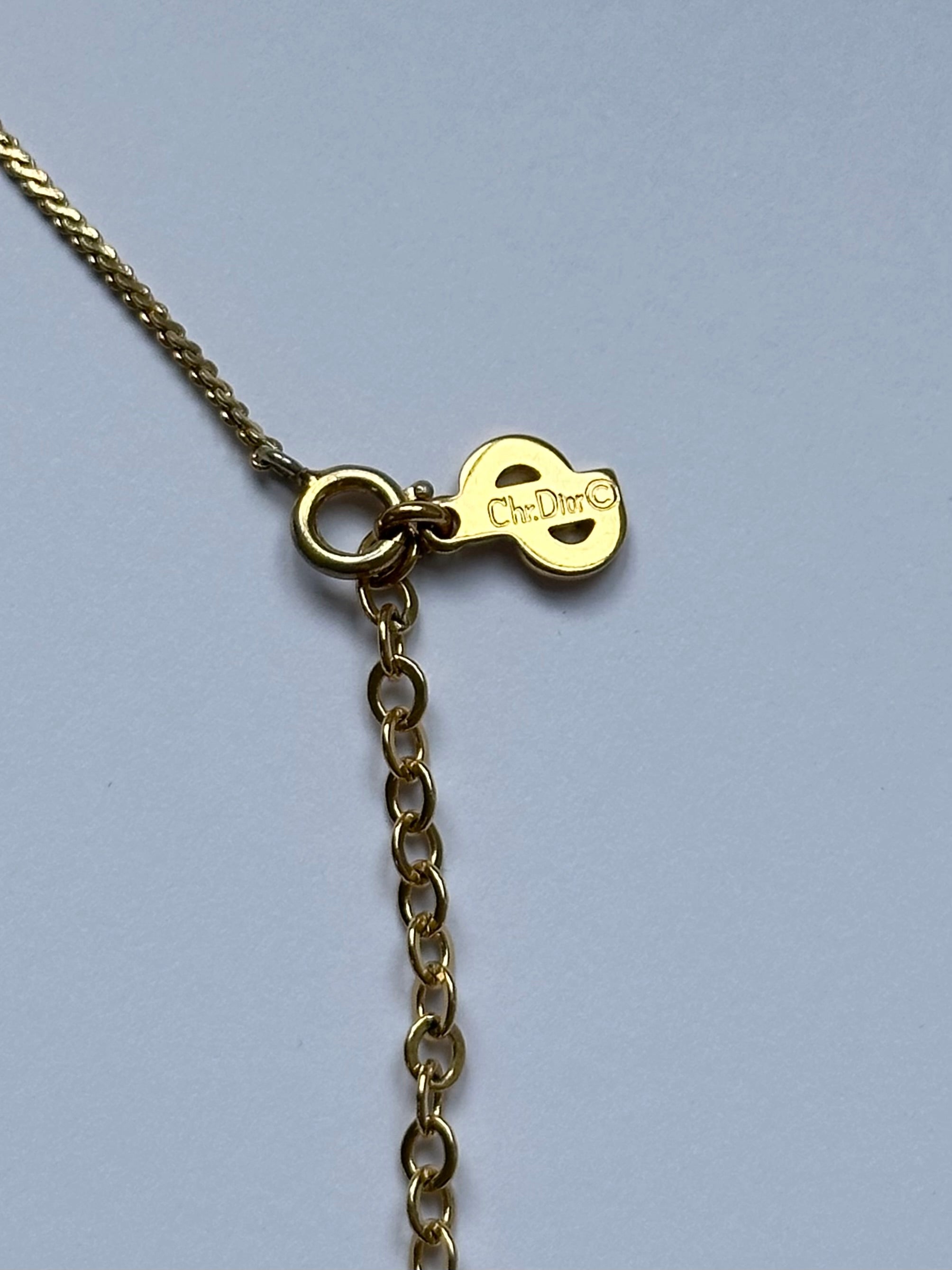 Christian Dior 16-inch gold plated logo pendant necklace with a sleek chain and iconic Dior branding.
