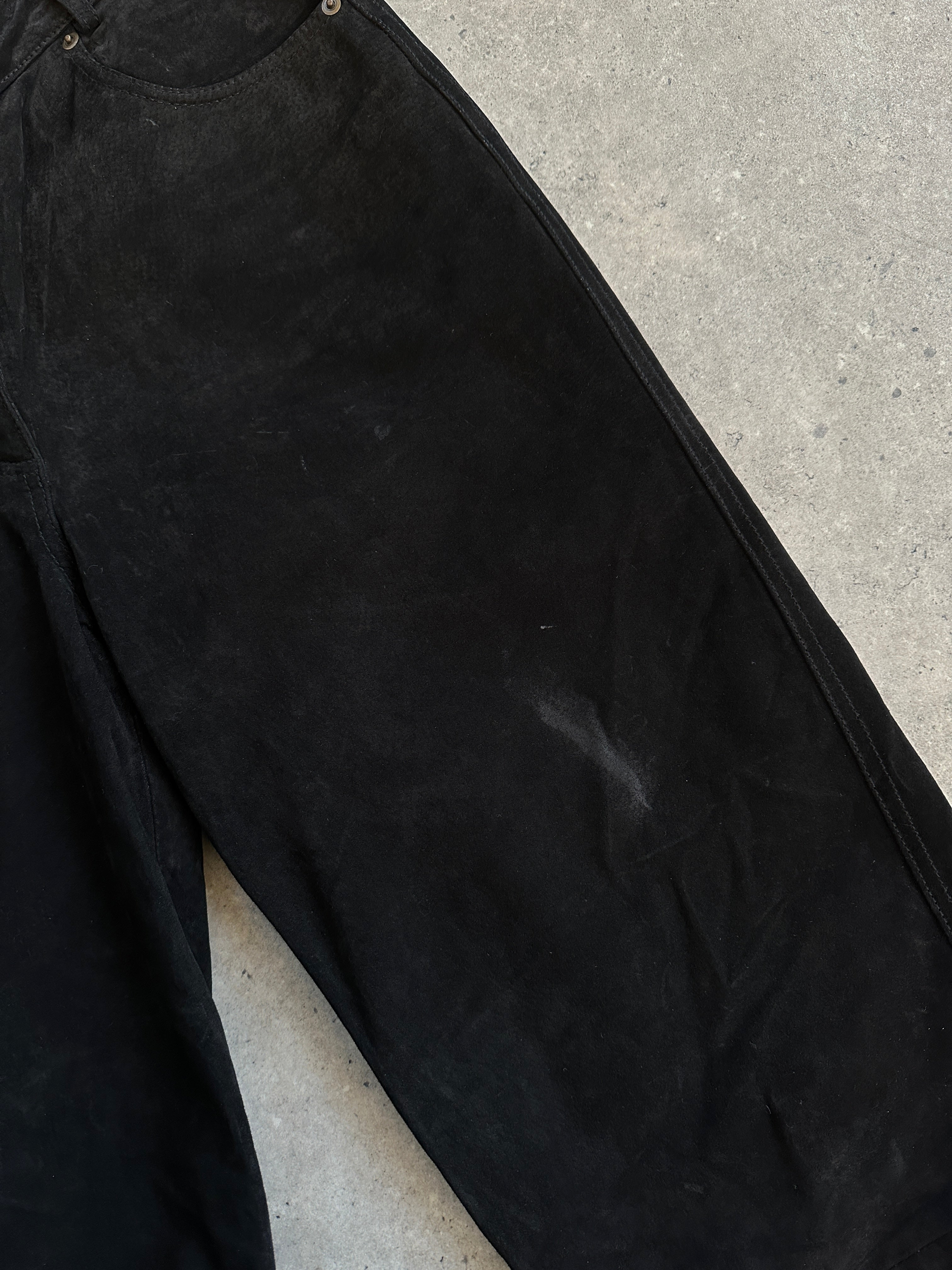 Vintage high waisted suede trousers in W26, featuring a classic fit and rich texture, shown laid flat with front details visible.
