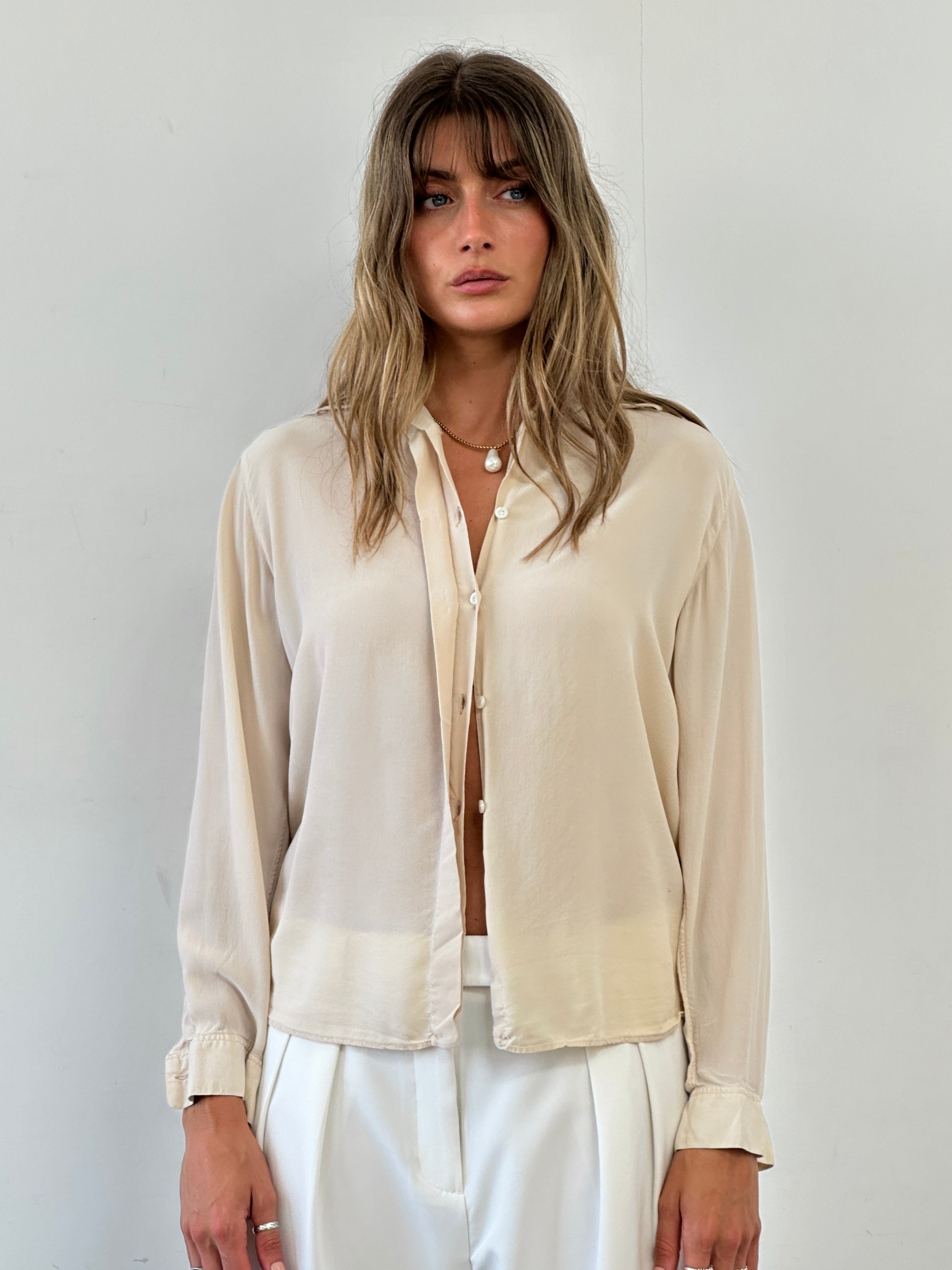 Elegant Vintage Italian vintage pure silk blouse with concealed placket, short sleeves, in size S, showcasing a luxurious, smooth fabric.