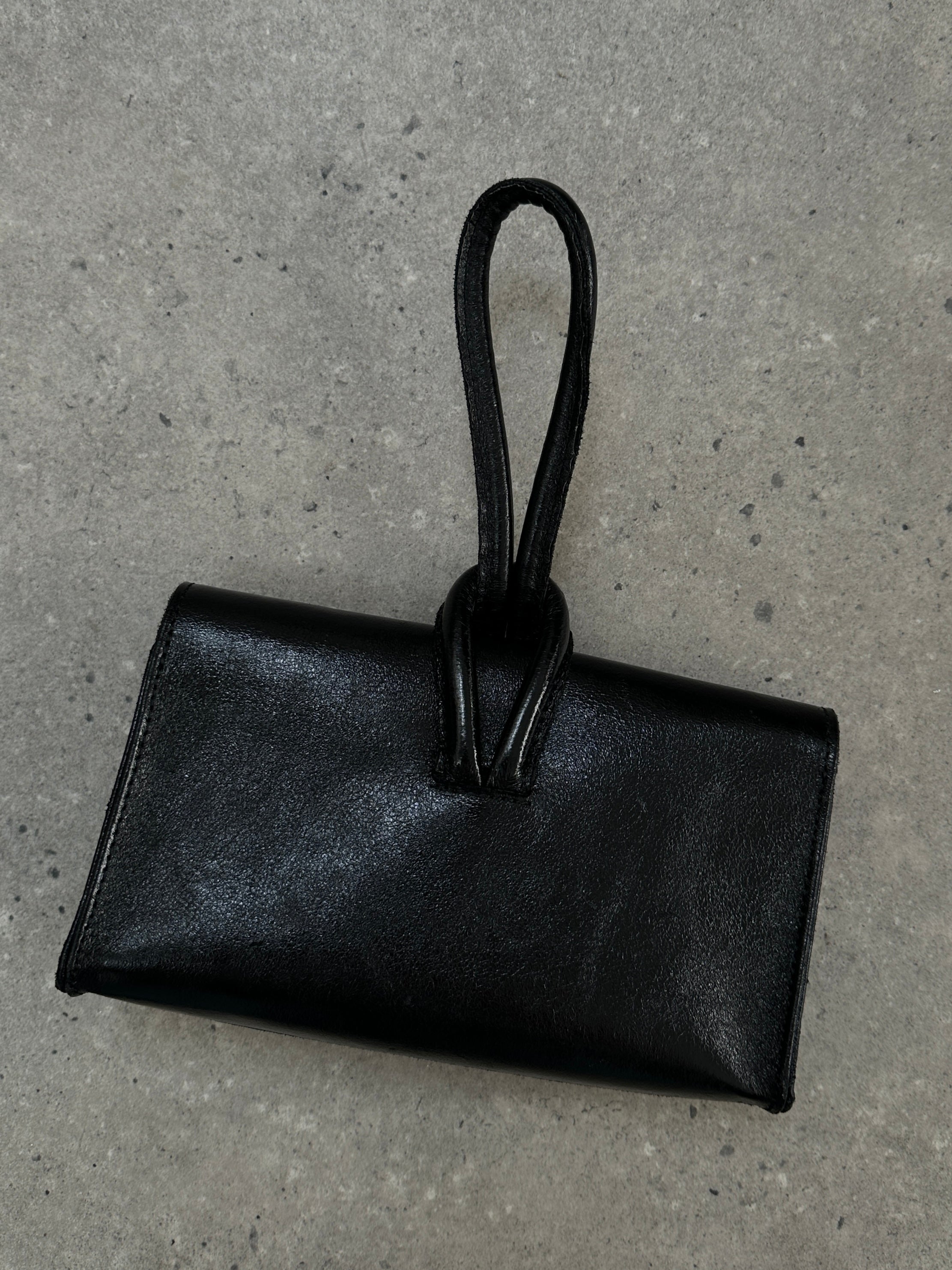 Vintage Italian leather crossbody clutch bag with a classic, worn-in look, featuring a compact design and vintage-style hardware.
