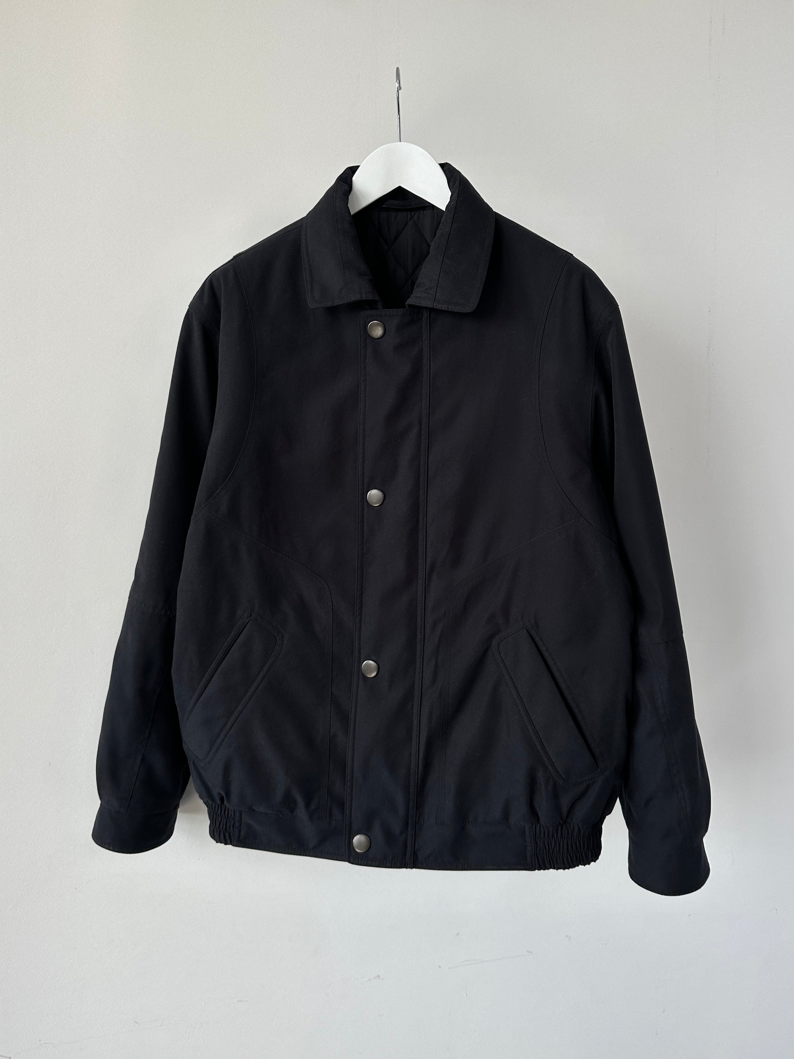 Vintage padded bomber jacket, size large, showing a classic design with quilted padding and ribbed cuffs and collar.