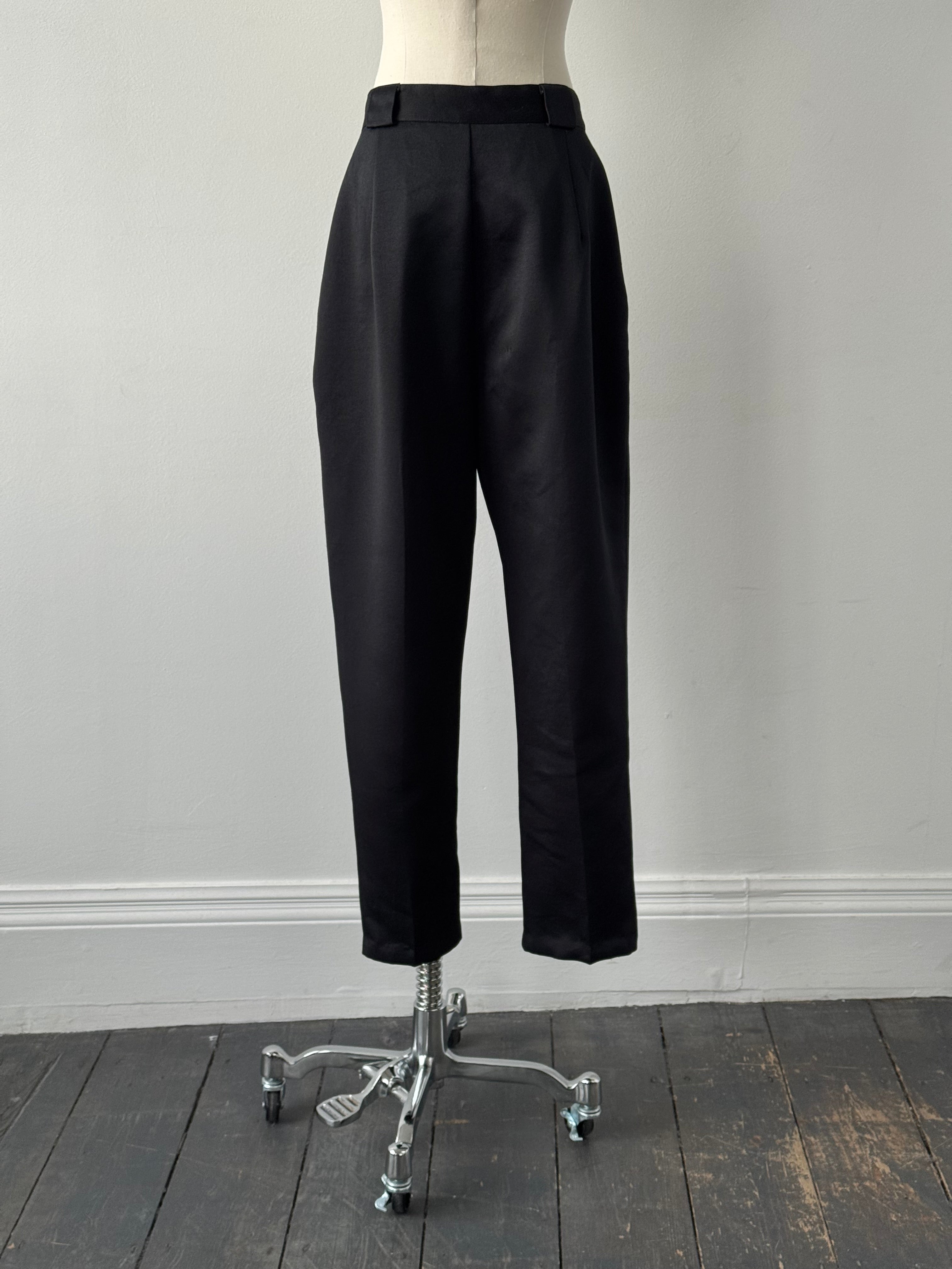 Vintage 1980s satin tapered leg high-waisted trousers in black, featuring a classic vintage style and W26 size.