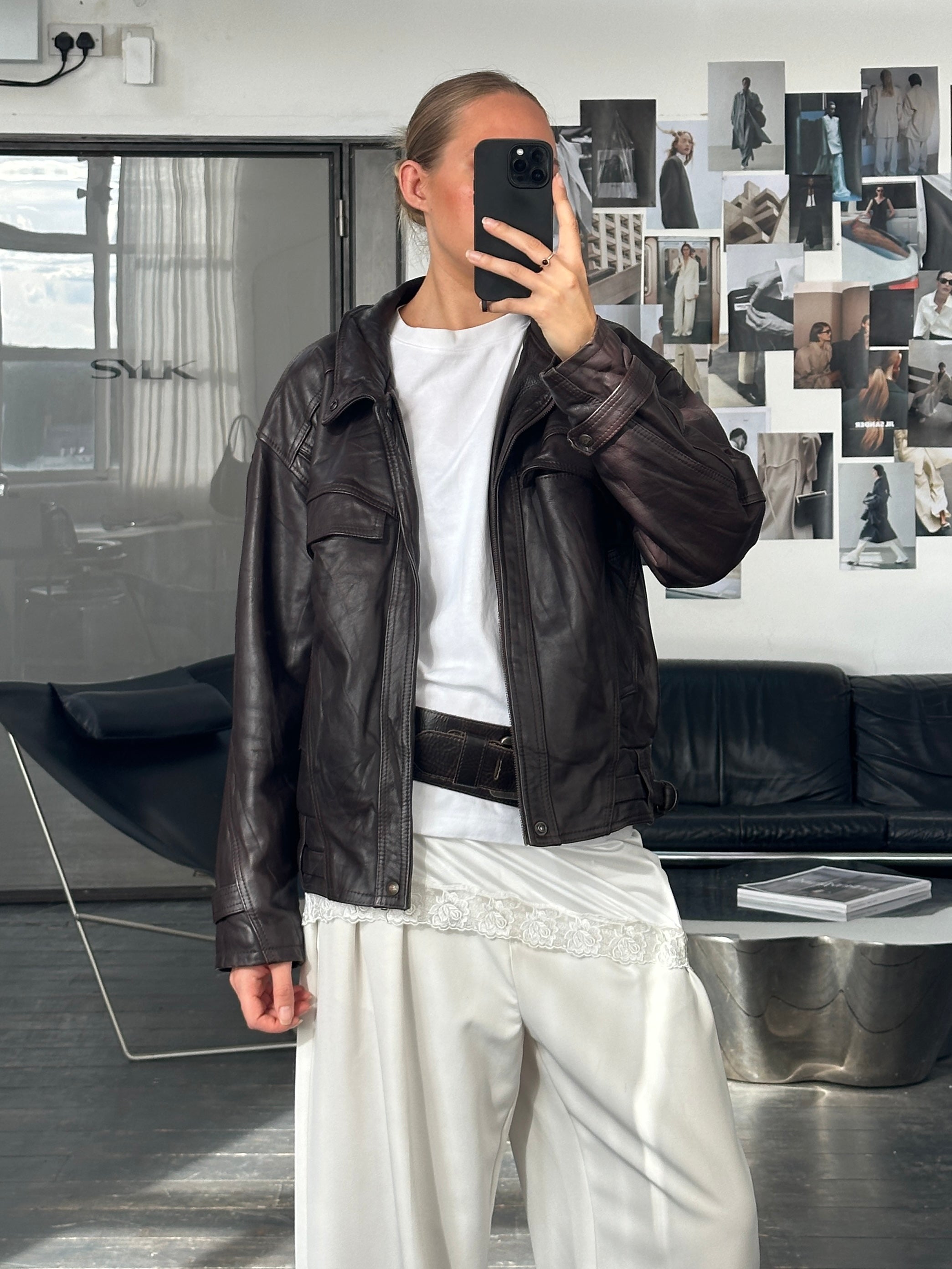 Vintage French 1980s high neck leather bomber jacket, size large, with classic design and textured black leather.