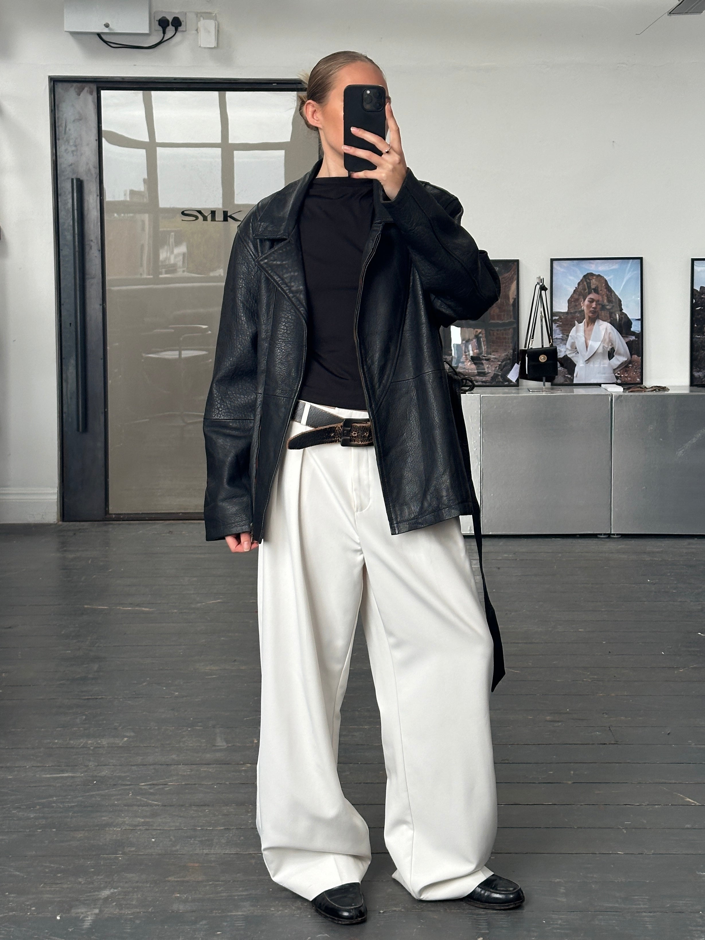 Vintage 1990s Lamb leather belted jacket in XL with classic style and detailed stitching, displayed on a hanger.