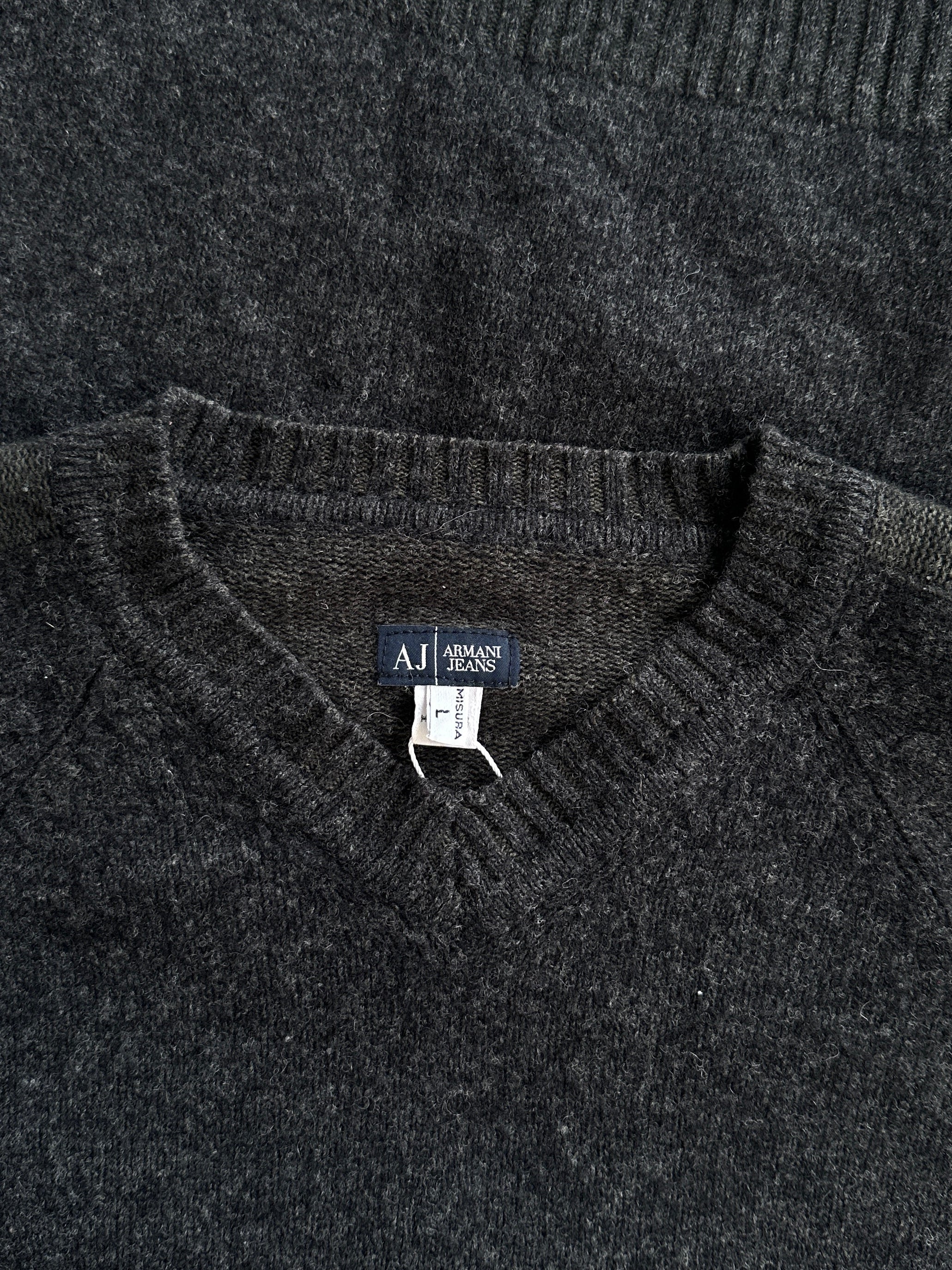 Armani Jeans wool V-neck jumper in size M/L, featuring a classic design with a ribbed collar and long sleeves, displayed on a hanger.