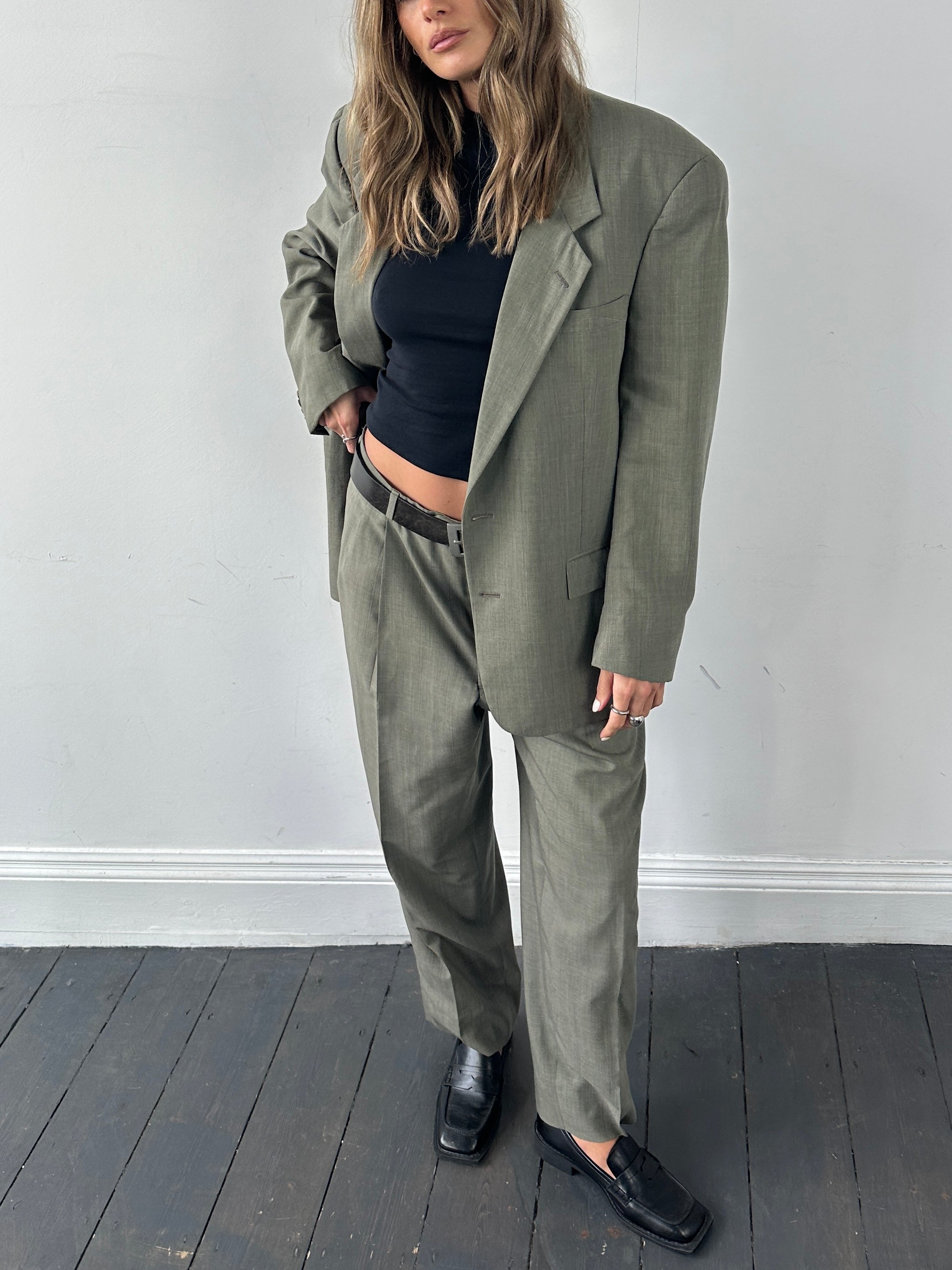 Christian Dior virgin wool single-breasted jumpsuit in size 42R/W32, tailored fit with lapel collar and button closure.