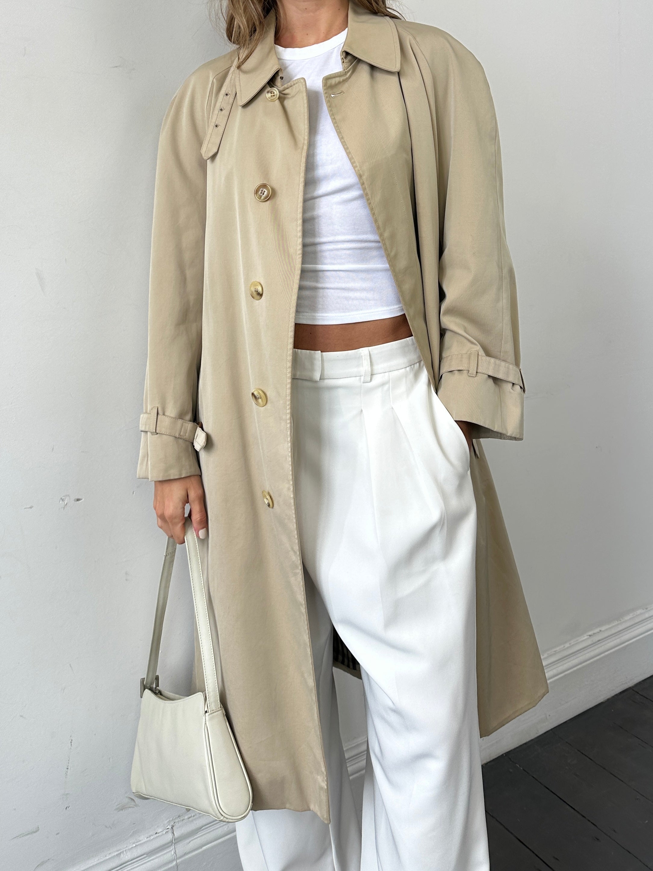 Aquascutum pure cotton trench coat with concealed placket and belt in size large, beige color, displayed on a hanger.