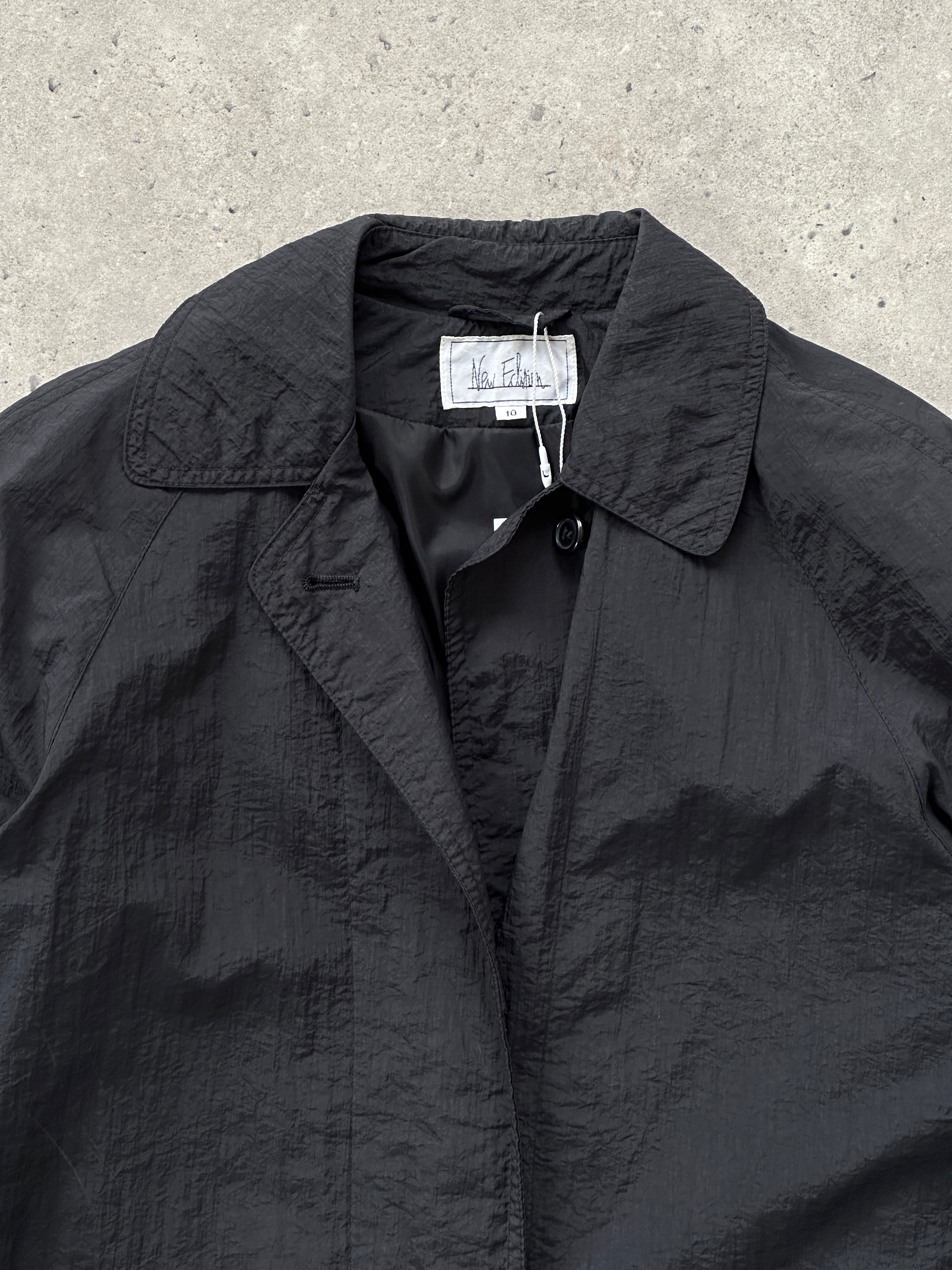 Vintage nylon trench coat with concealed placket in size S, featuring a classic design and a sleek, lightweight silhouette.