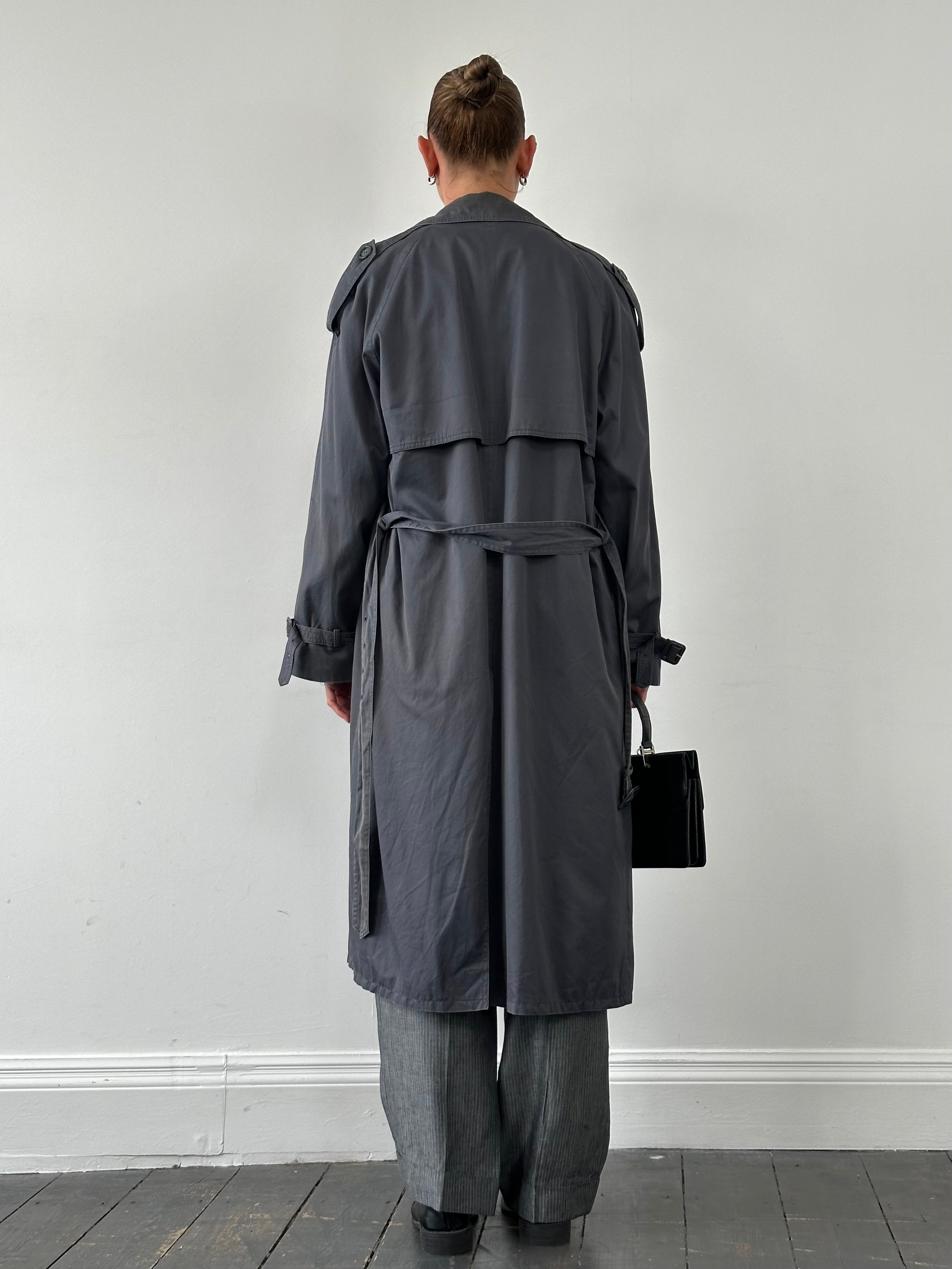 Yves Saint Laurent cotton double-breasted belted trench coat in XL, shown hanging with classic collar and button details.