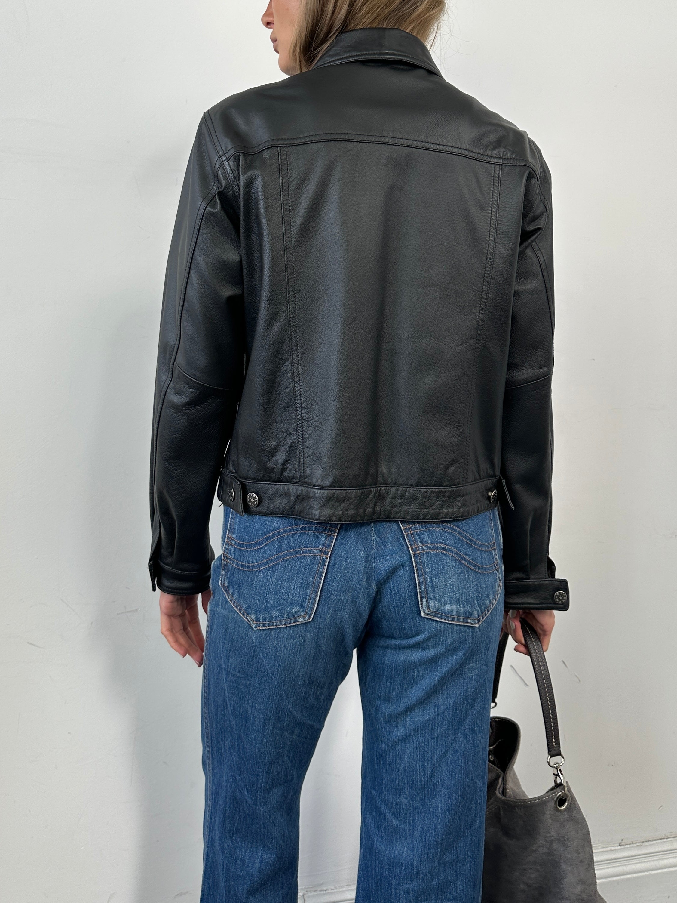 Vintage boxy leather jacket in black with a classic collar and zipper front, styled with long sleeves and a cropped fit.