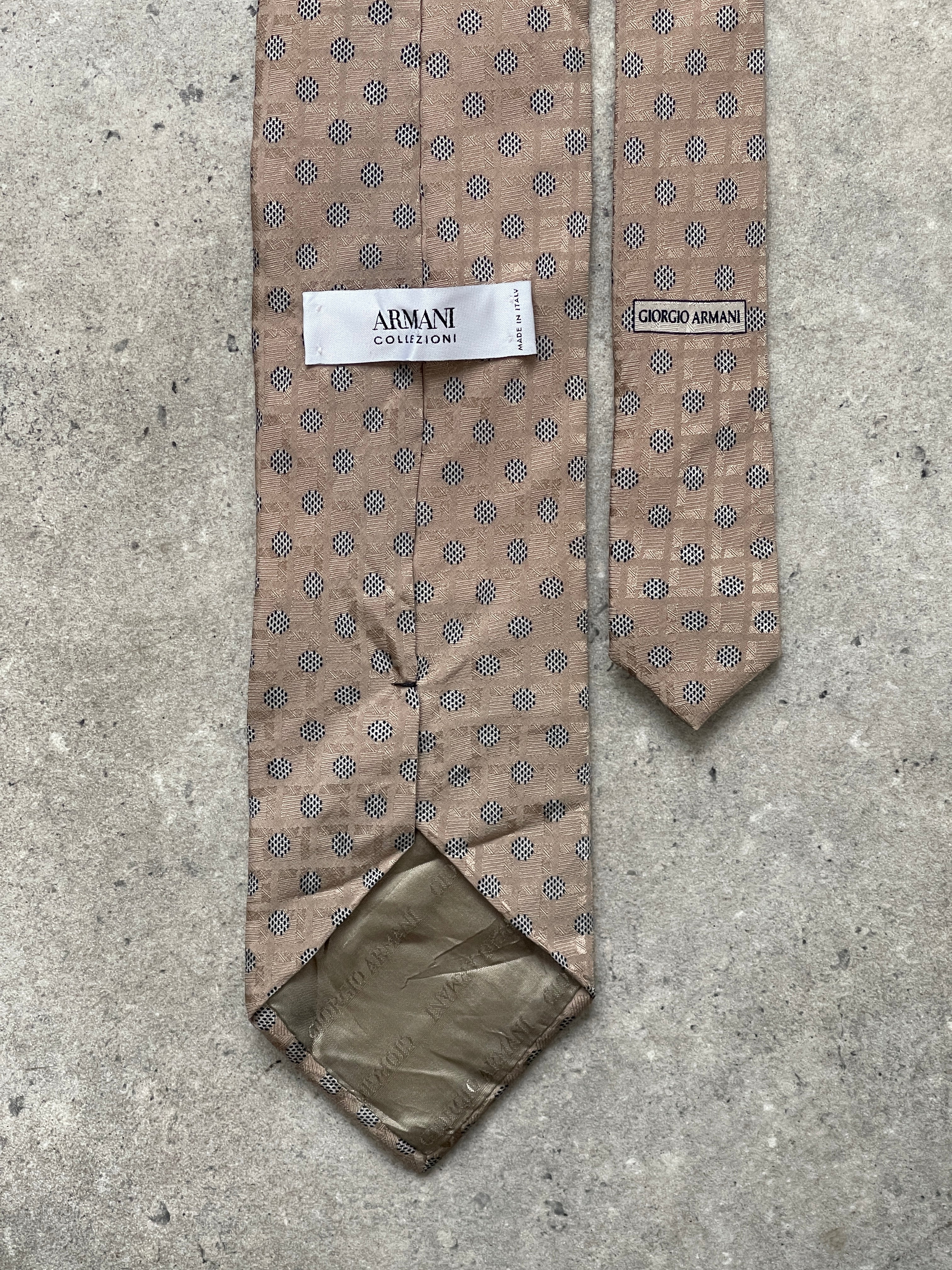 Armani Collezioni 2000s pure silk polkadot tie with navy background and white dots, showcasing elegant craftsmanship.