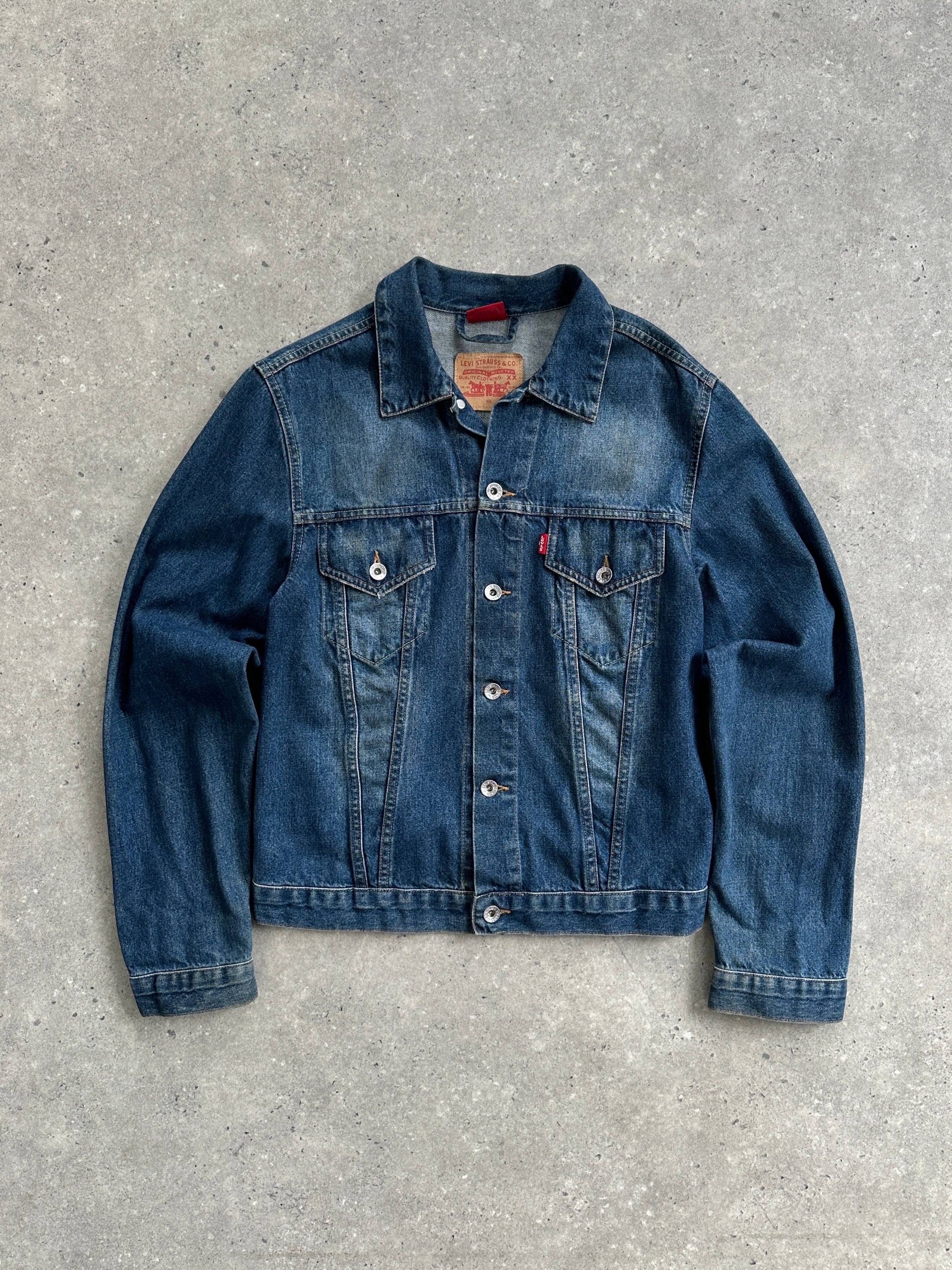 Levi’s faded denim jacket in size S, featuring a classic fit with distressed details and button-front closure.