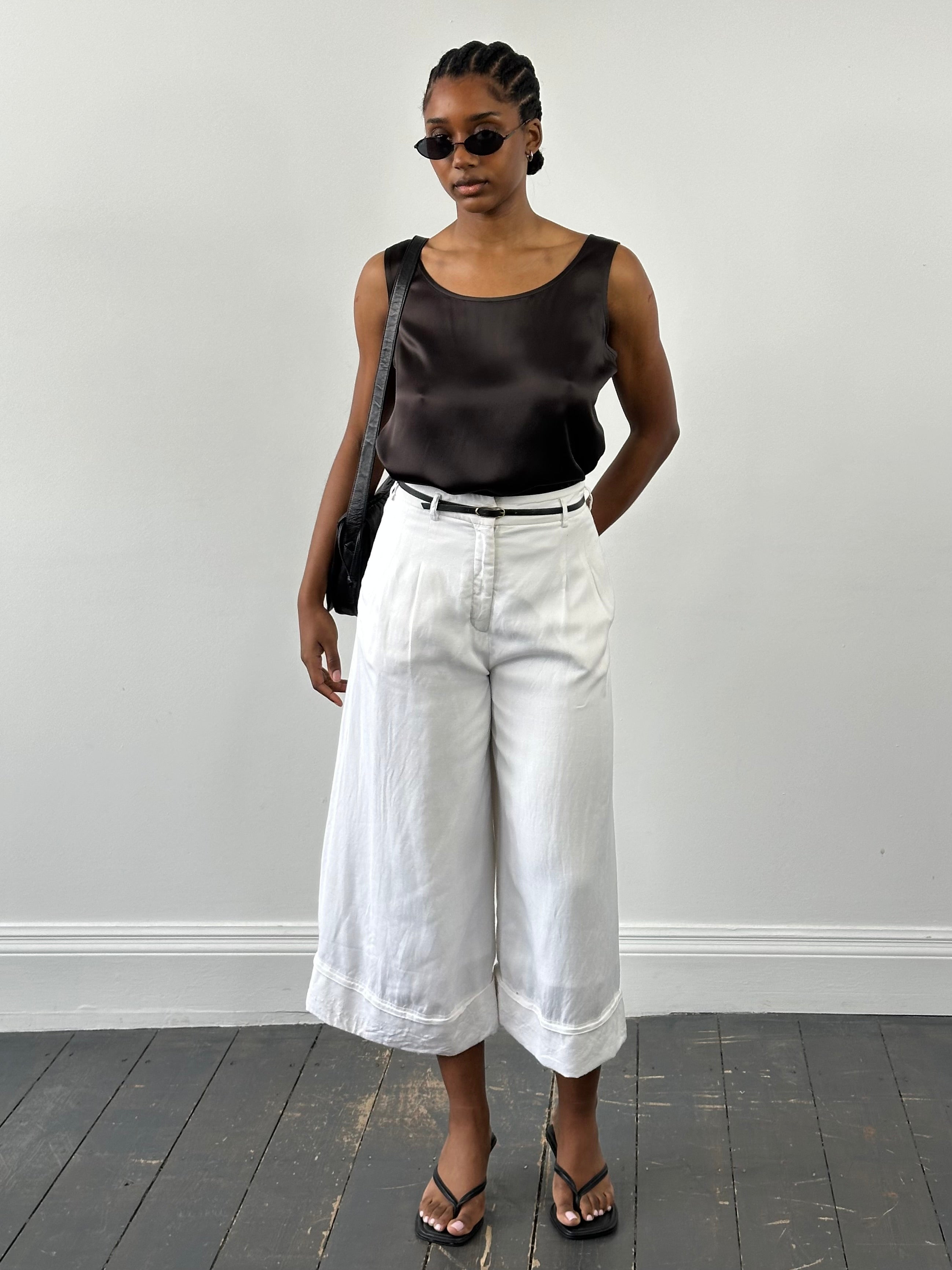 Japanese vintage 1990s high-waisted wide leg culottes shorts in size W26, featuring a classic retro style and flowy fabric.