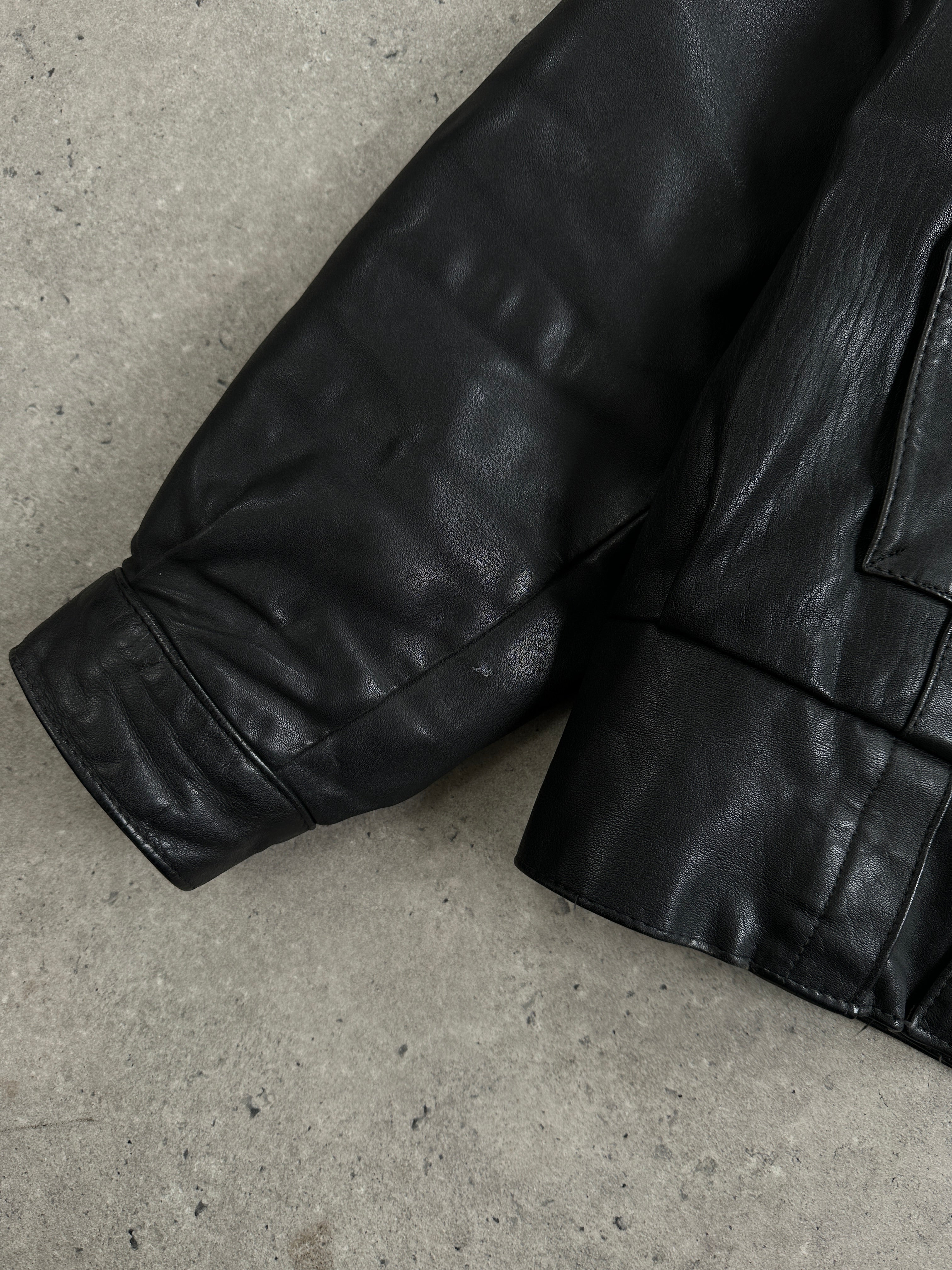 Vintage leather bomber jacket in size small, featuring classic design and aged leather texture.
