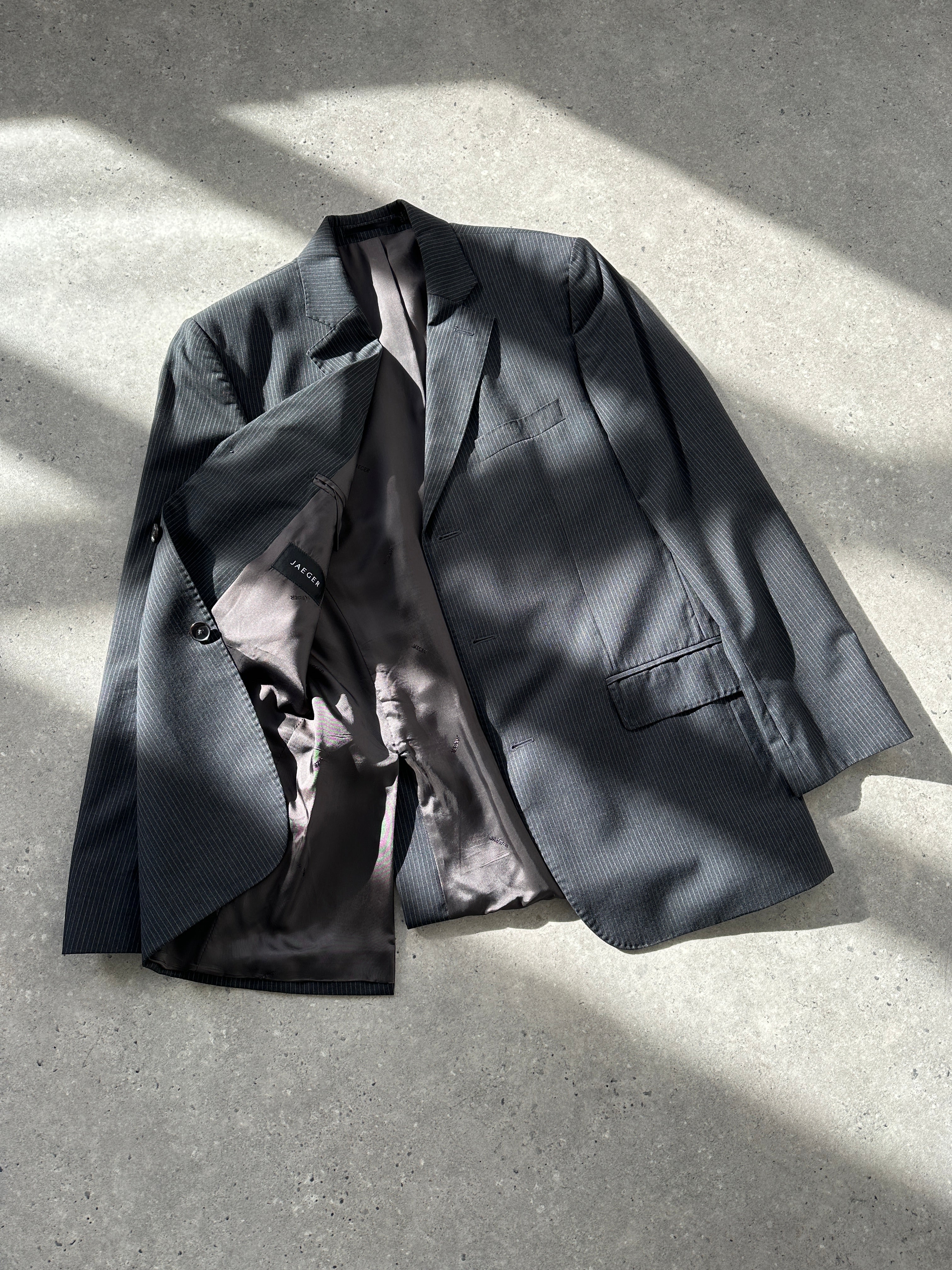 Jaeger pure wool pinstripe blazer in size 40R/M, tailored fit, featuring classic pinstripe pattern and structured lapel.
