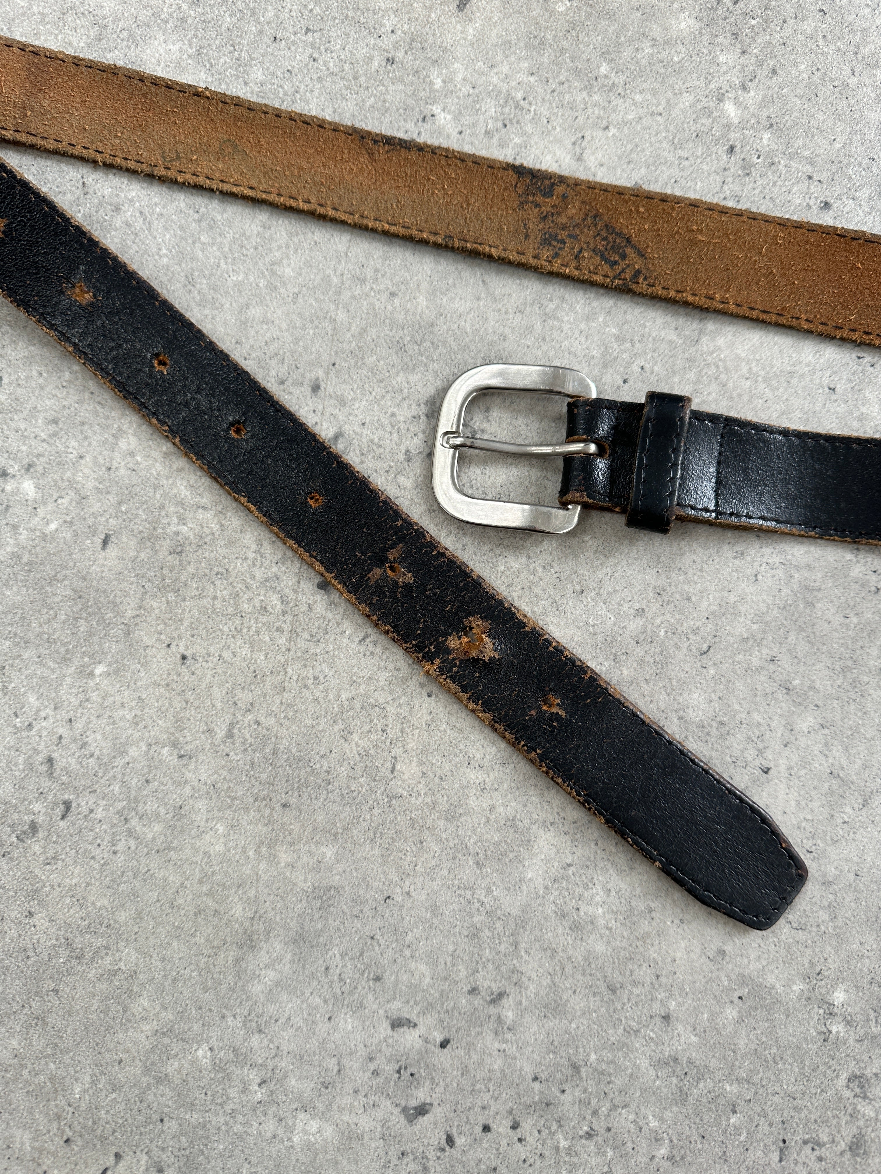 Vintage 1980s chrome distressed leather belt with metal buckle, showing worn leather and vintage style details.