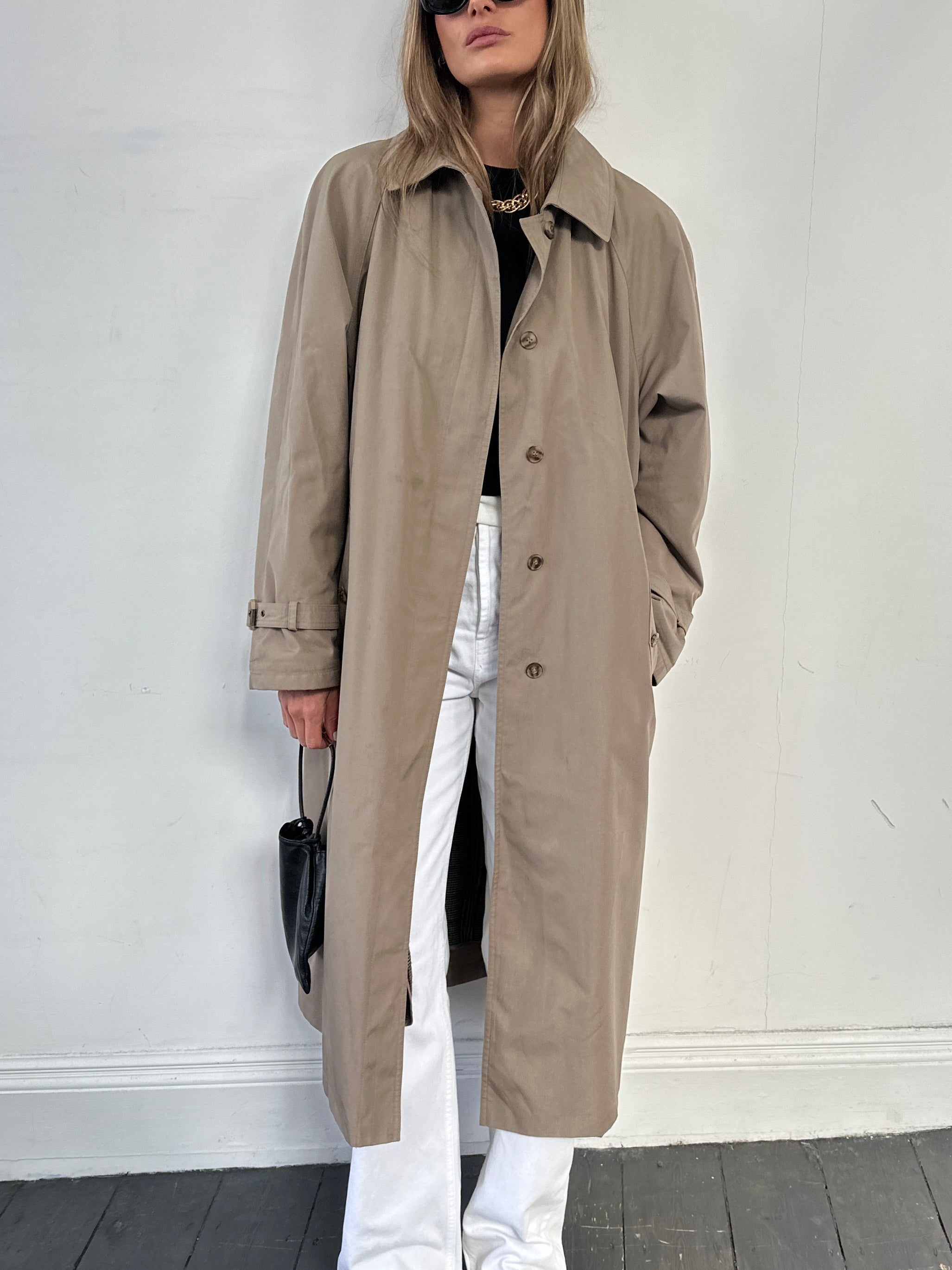 Vintage water-resistant trench coat with concealed placket in M/L size, showcasing classic design and durable fabric.