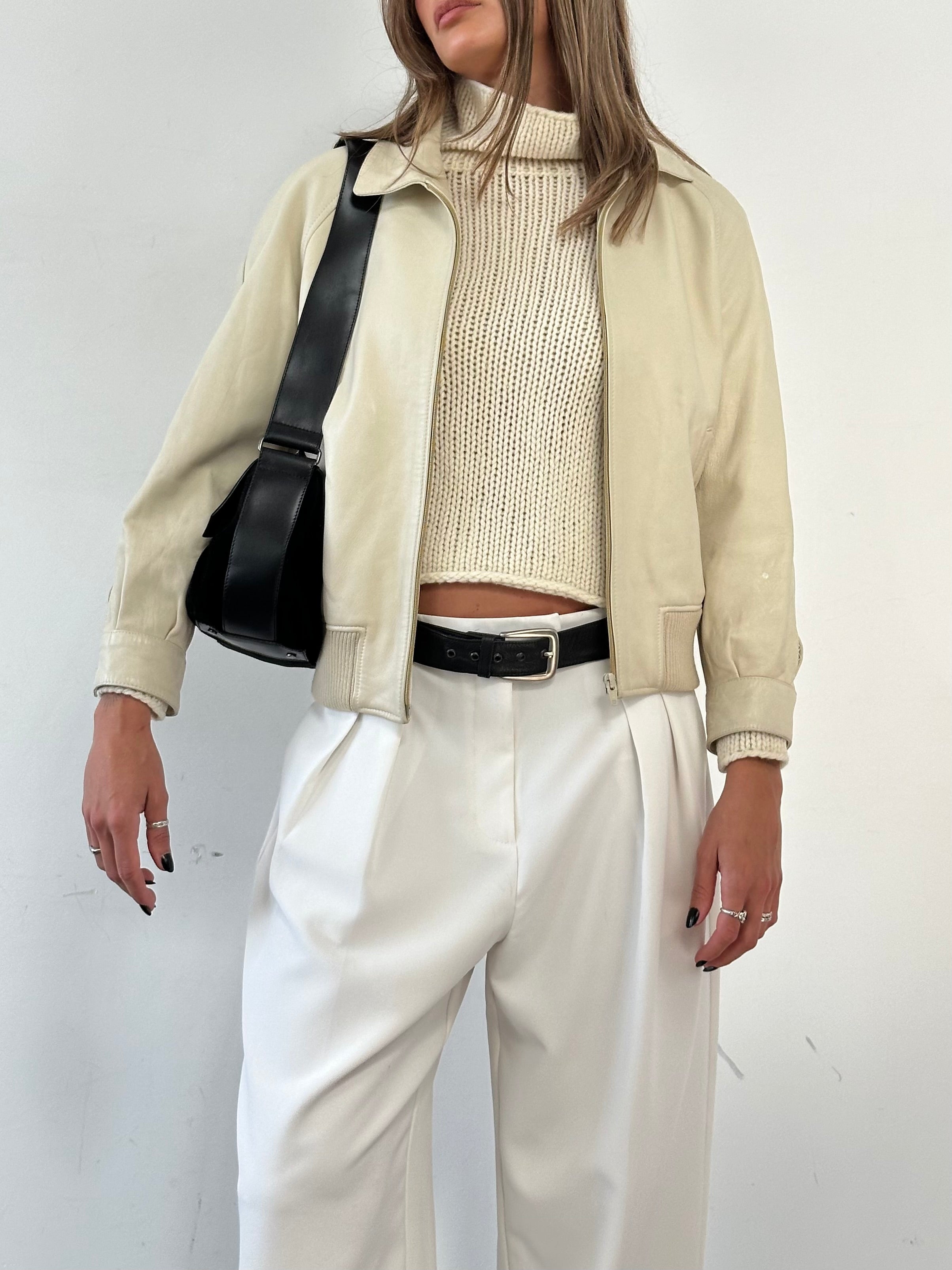 Vintage leather bomber jacket in size small, featuring classic design with ribbed cuffs and collar, stylish and durable.