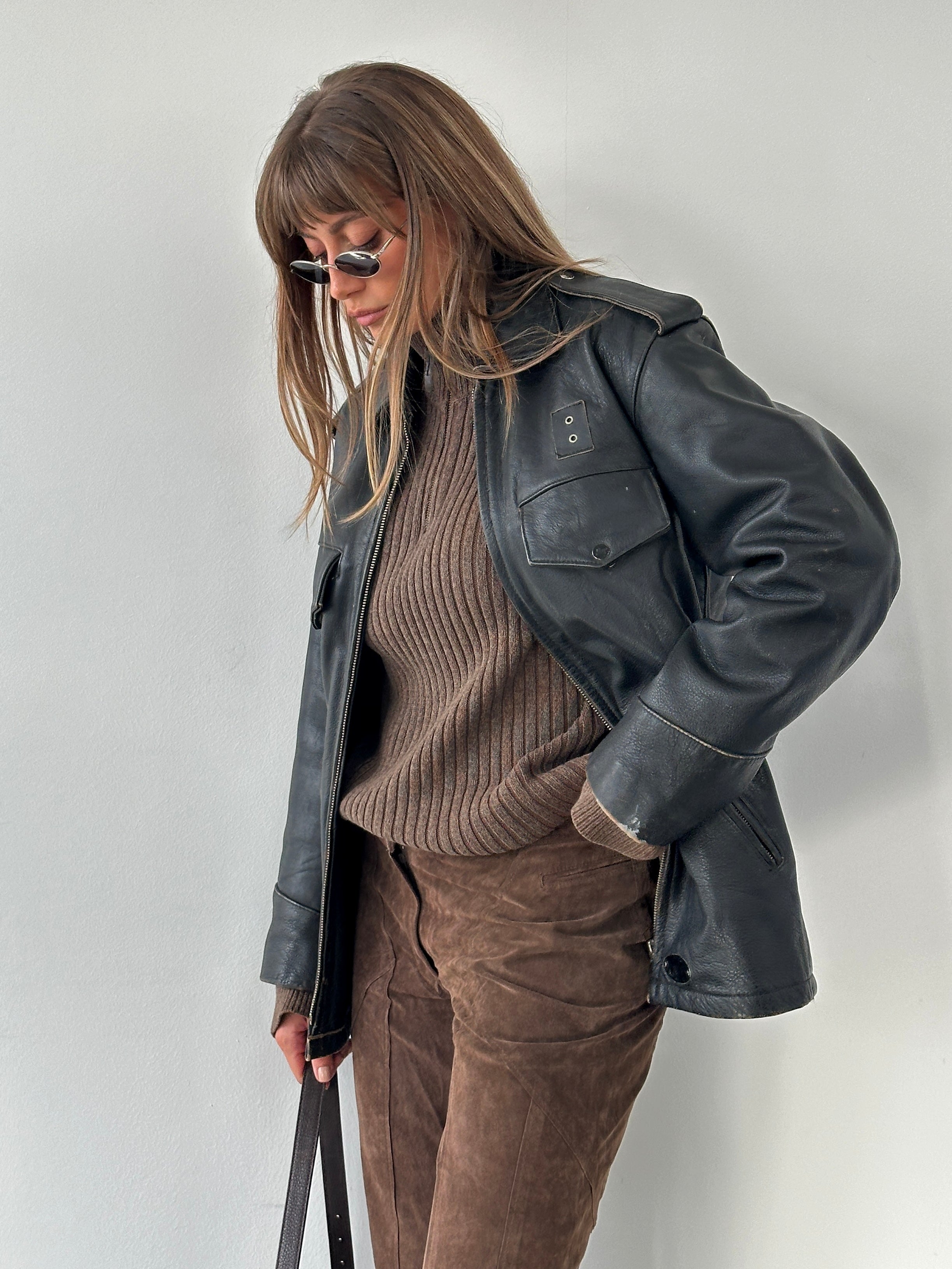 Vintage 1990s aged leather jacket in size M/L, featuring distressed brown leather and classic style with rugged details.