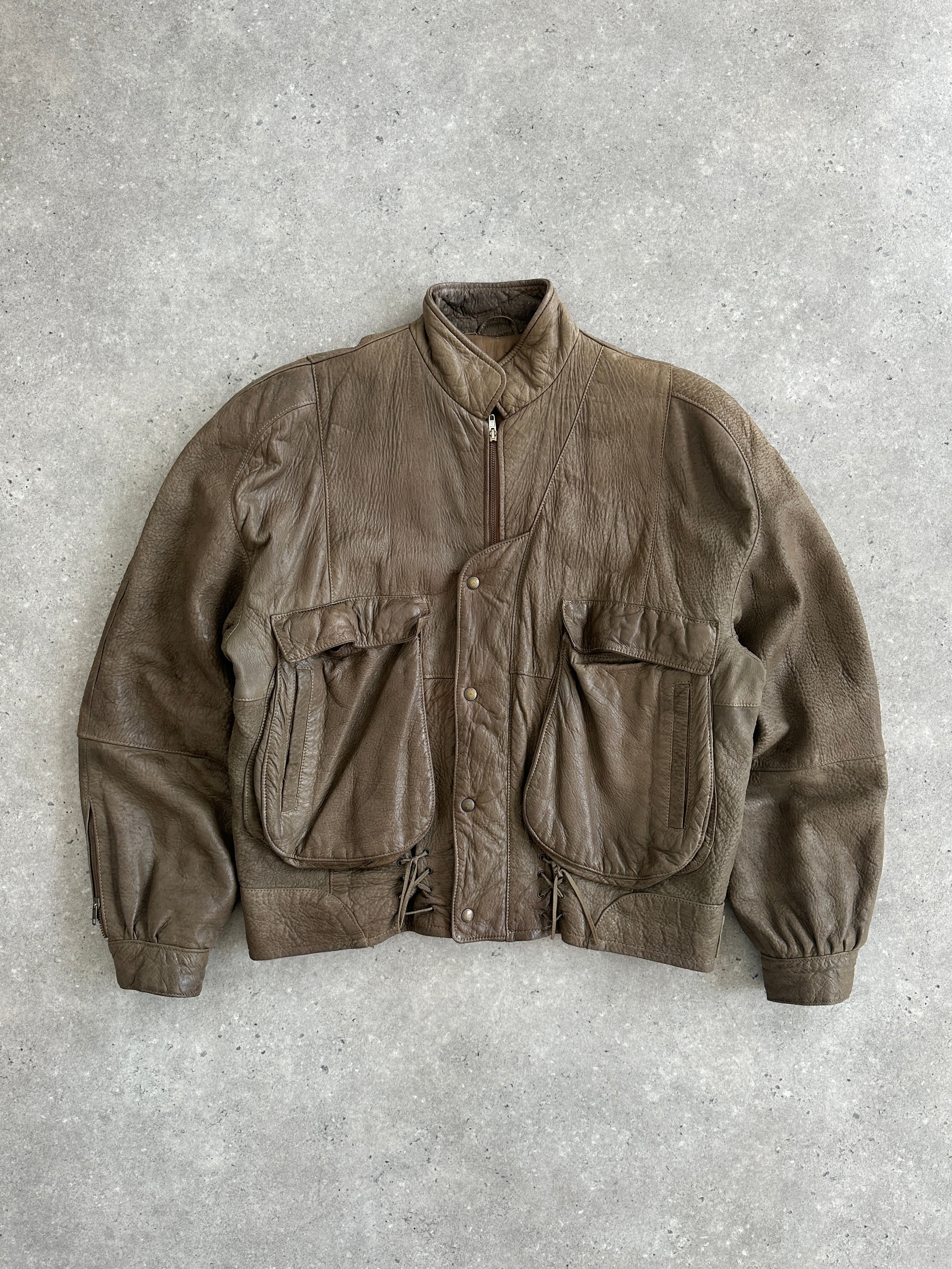 Vintage 1980s leather moto jacket in size large, featuring classic design and rugged texture, perfect for vintage style enthusiasts.