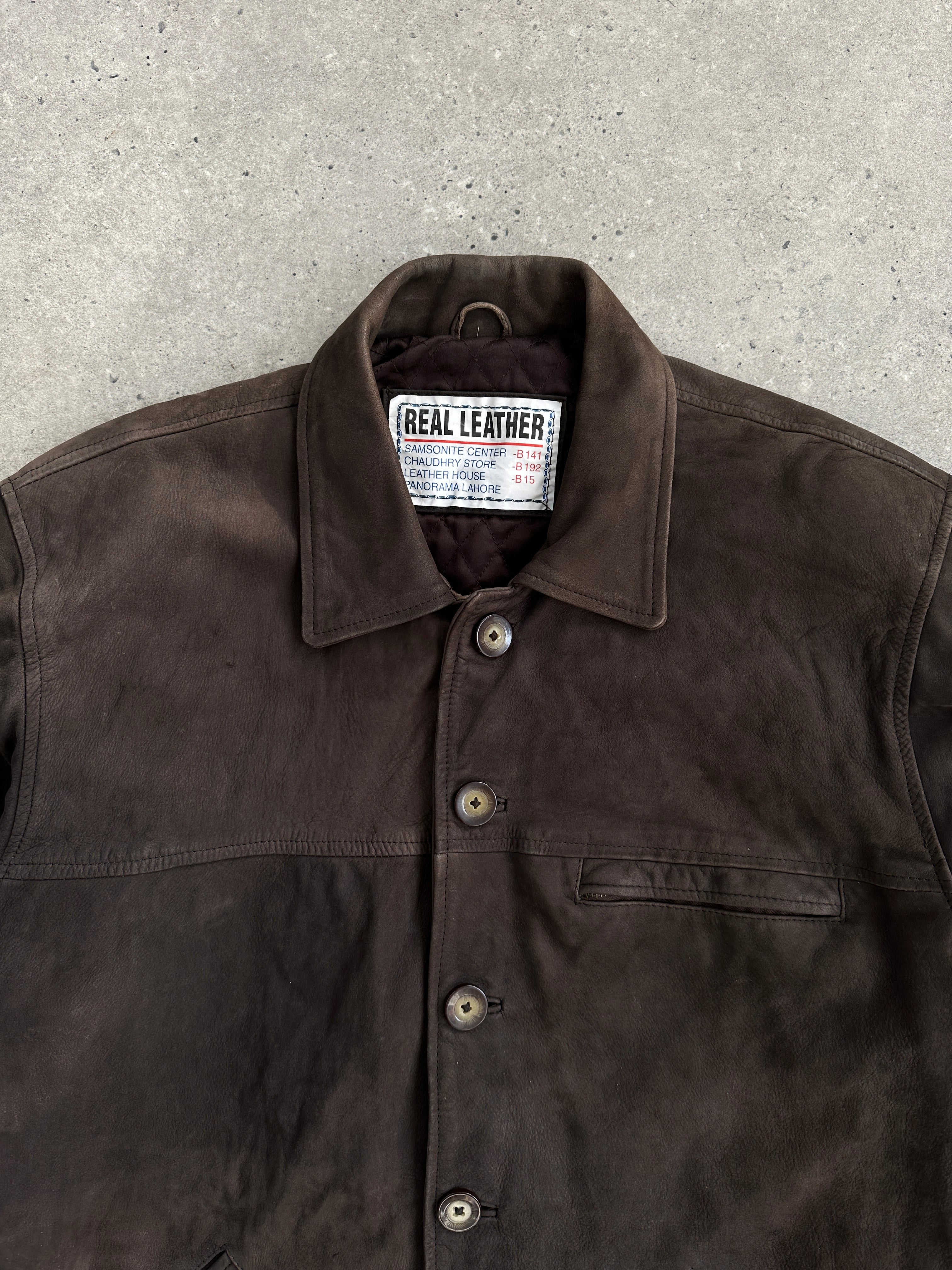 Vintage XL nubuck leather jacket displayed on a hanger, showcasing its classic style and soft textured leather.