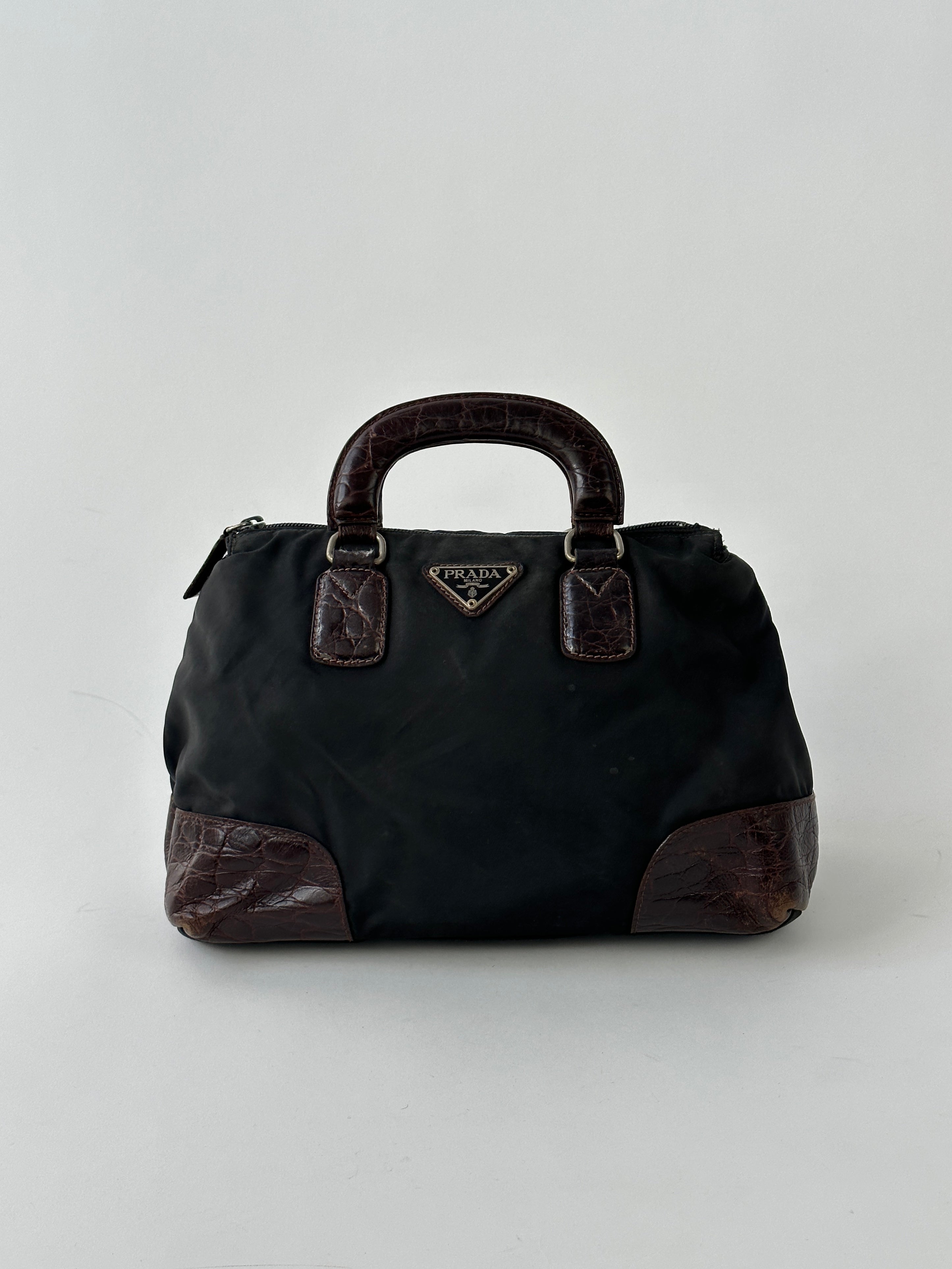 Prada nylon croc handbag with sleek design, featuring textured crocodile pattern and sturdy nylon straps.