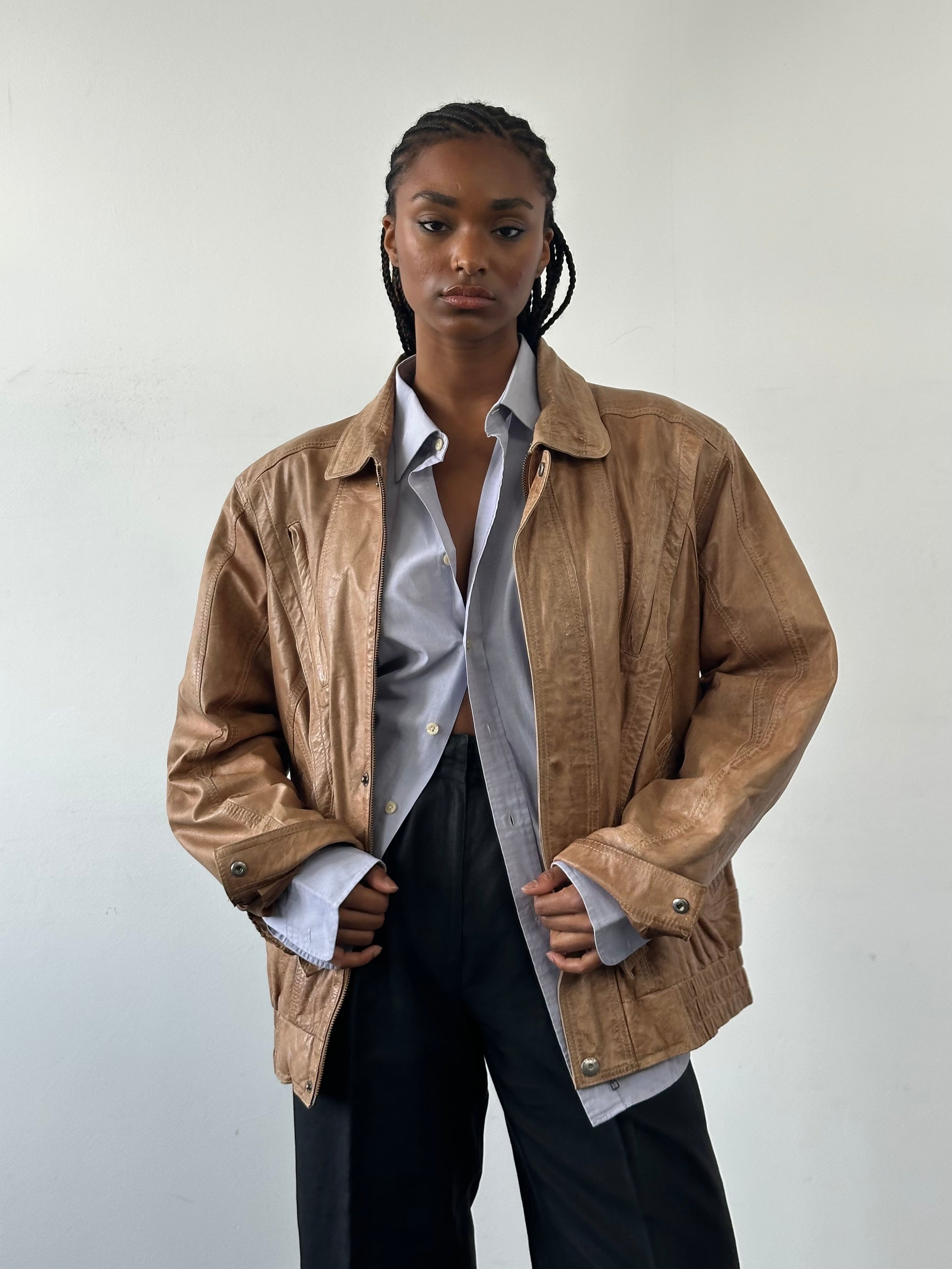 Vintage 1990s leather bomber jacket in size large, featuring classic design and aged leather from the Vintage brand.