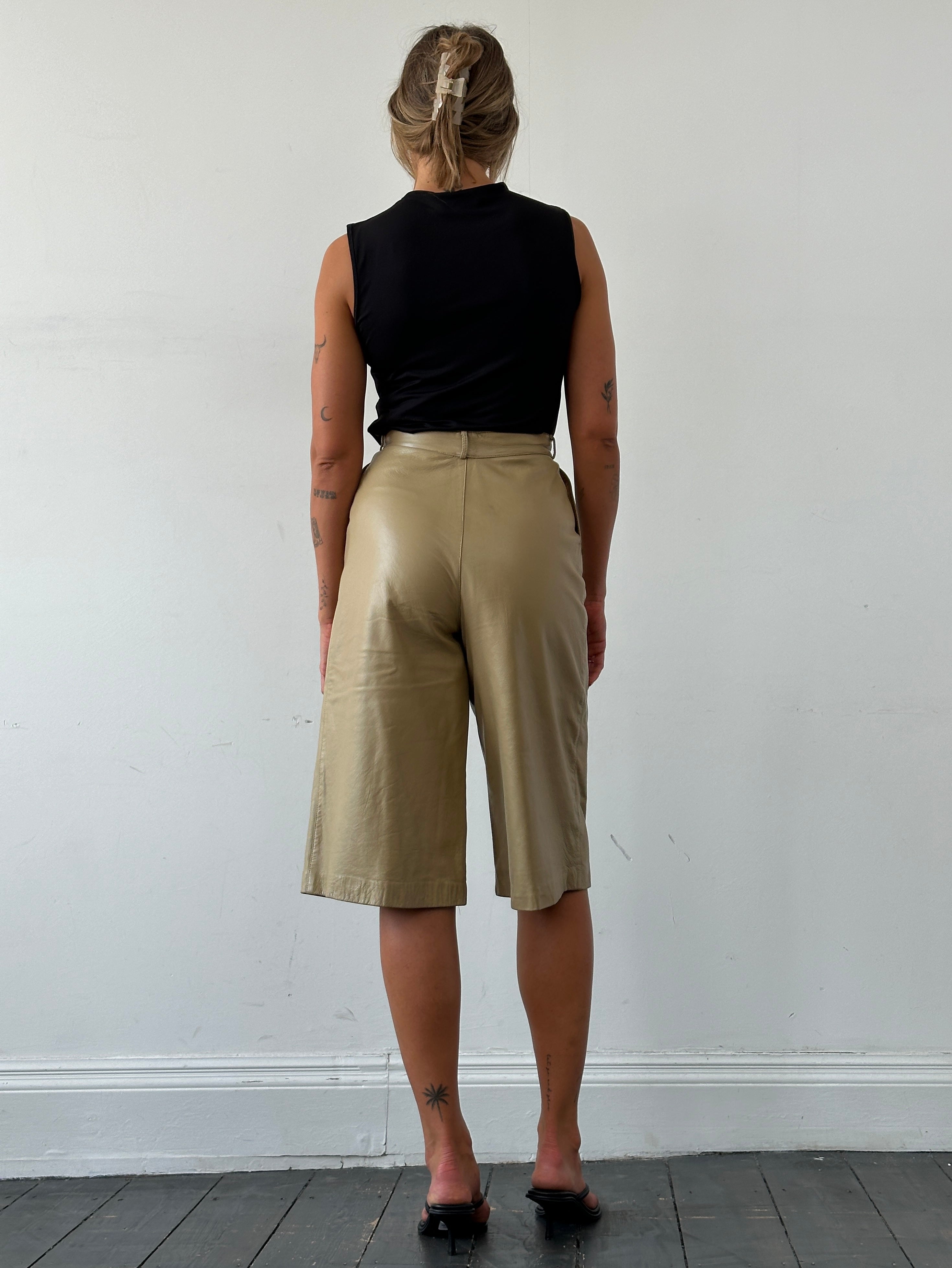 Vintage leather wide-leg high-waisted long shorts, showing their textured leather surface and relaxed fit.