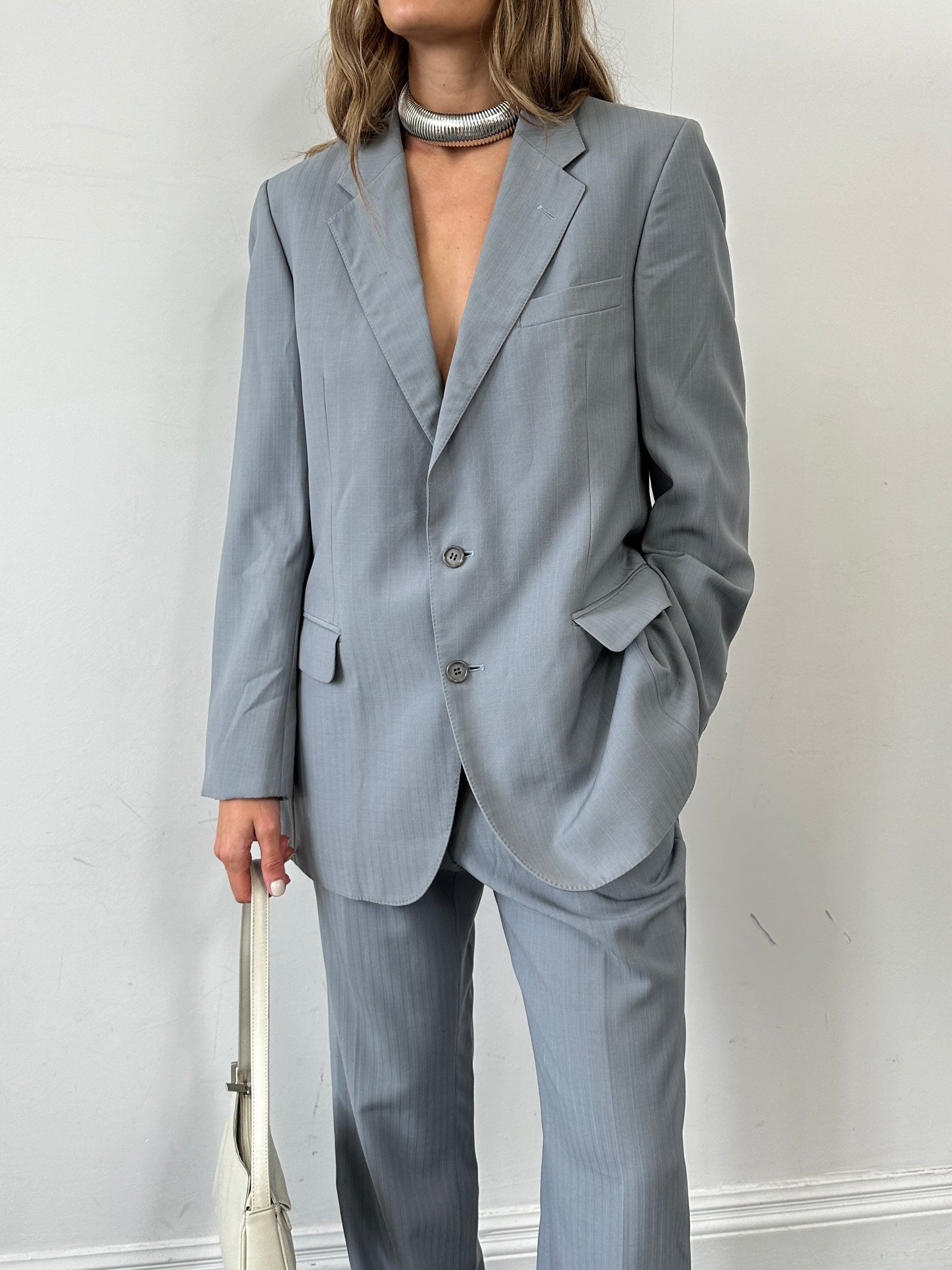 Christian Dior pure wool single-breasted suit jumpsuit in size 44R/W32, tailored fit with lapel collar and front buttons.