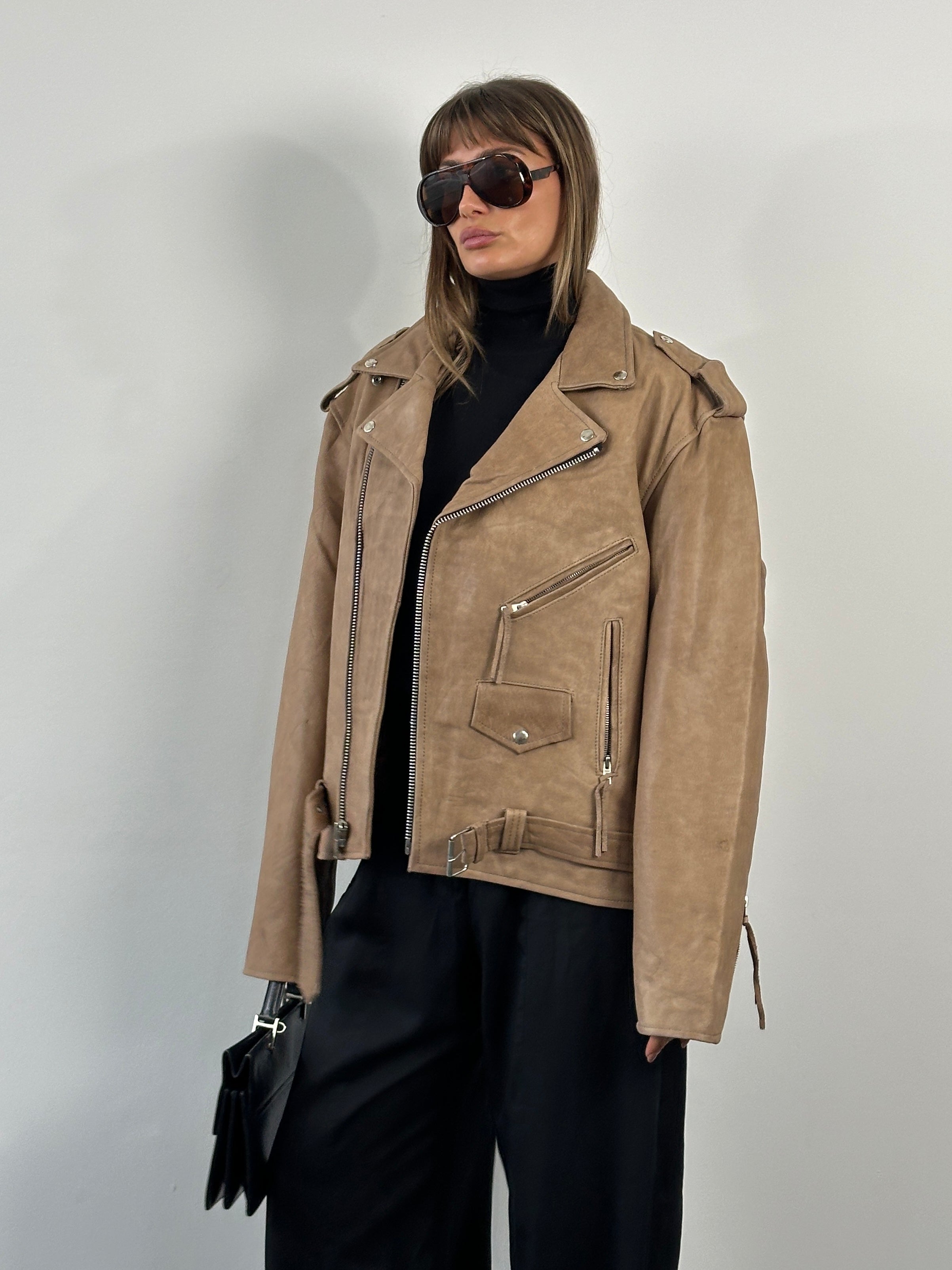 Vintage 1990s leather biker jacket in XL, featuring classic rugged design, worn leather texture, and detailed stitching.