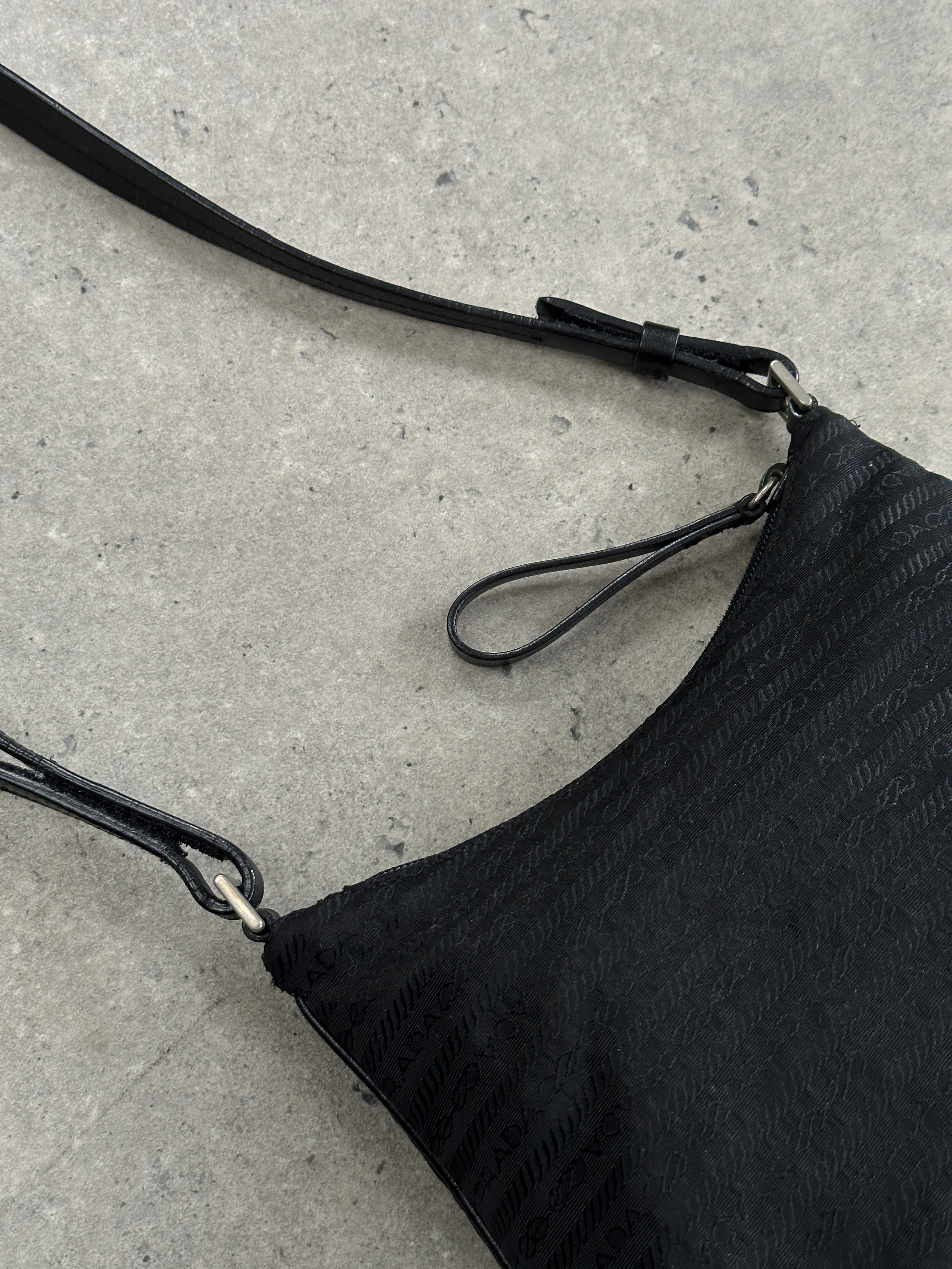 Prada nylon Tessuto monogram crossbody bag with adjustable strap and logo detailing, stylish and functional accessory.