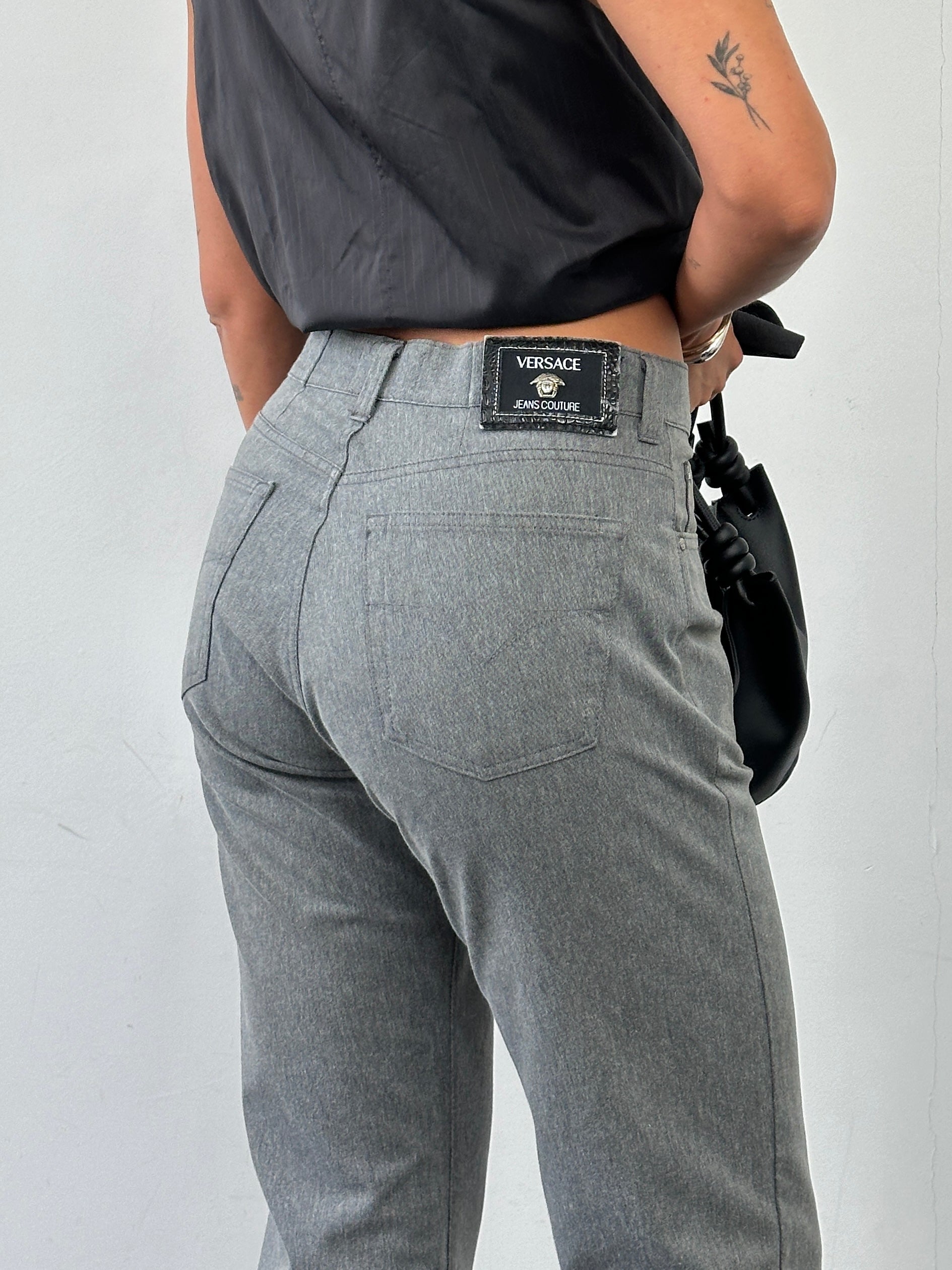 Versace Jeans Couture high waisted straight leg jeans in size W28 laid flat showing classic denim fabric and stitching details.