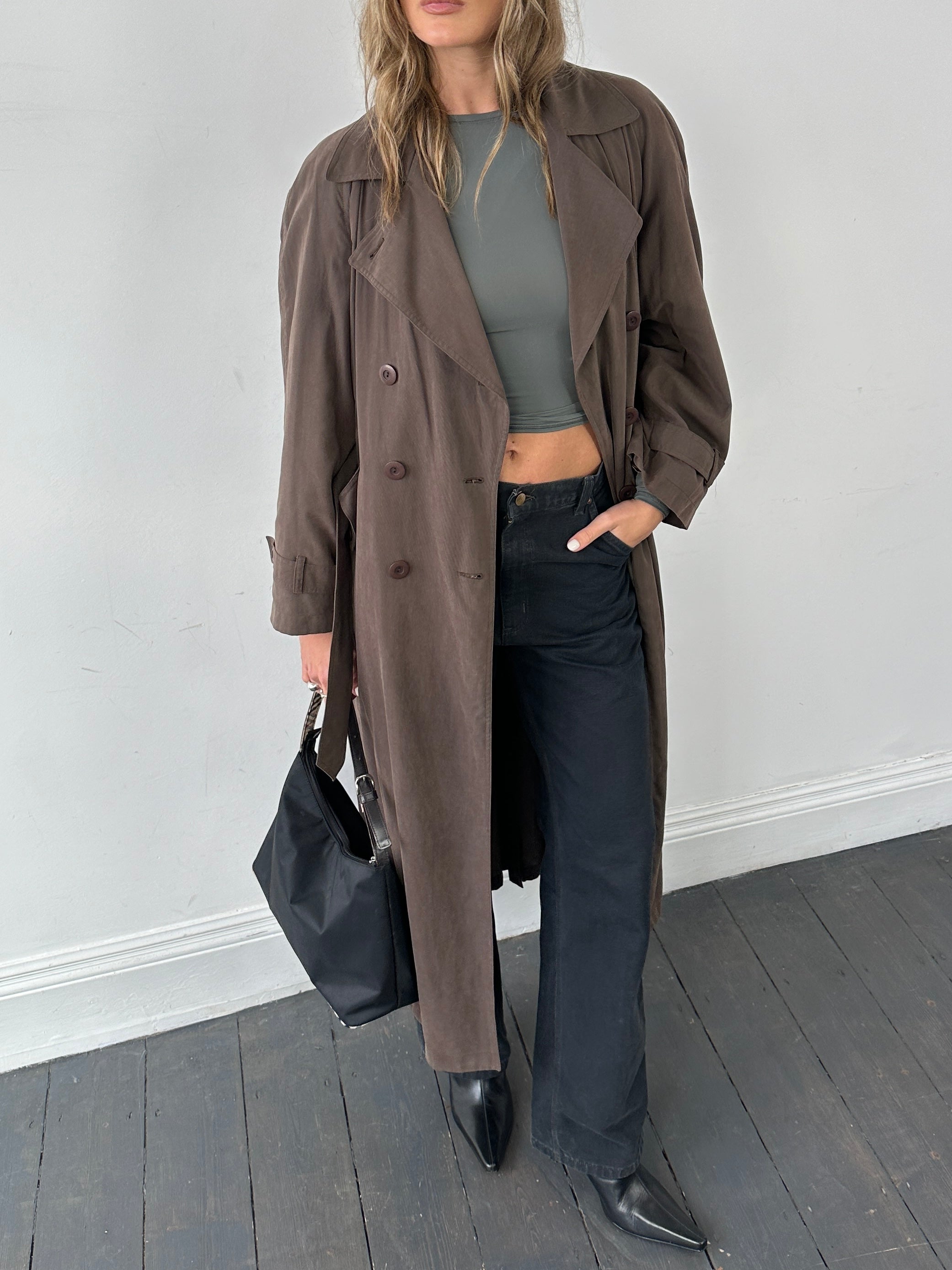 Marella double-breasted belted soft touch trench coat displayed on a hanger, showcasing its classic design and neutral color.