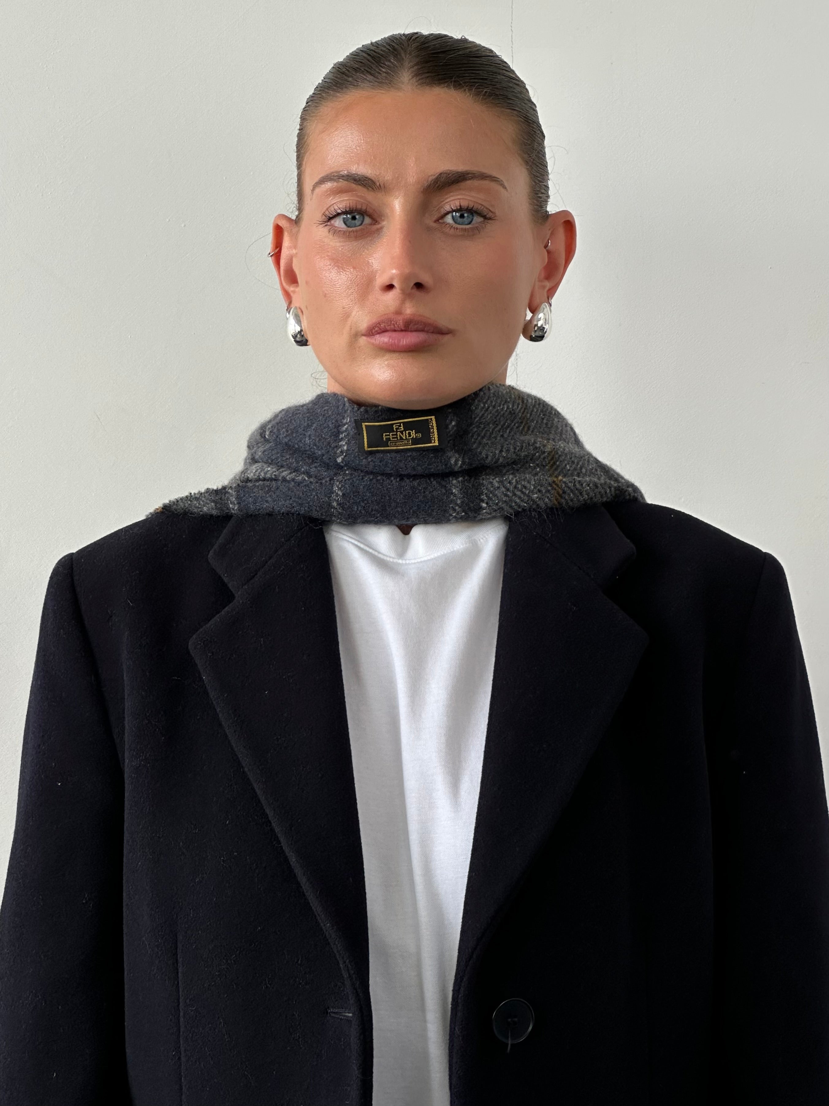 Fendi pure wool logo check scarf featuring classic pattern and soft texture, perfect for stylish cold-weather wear.