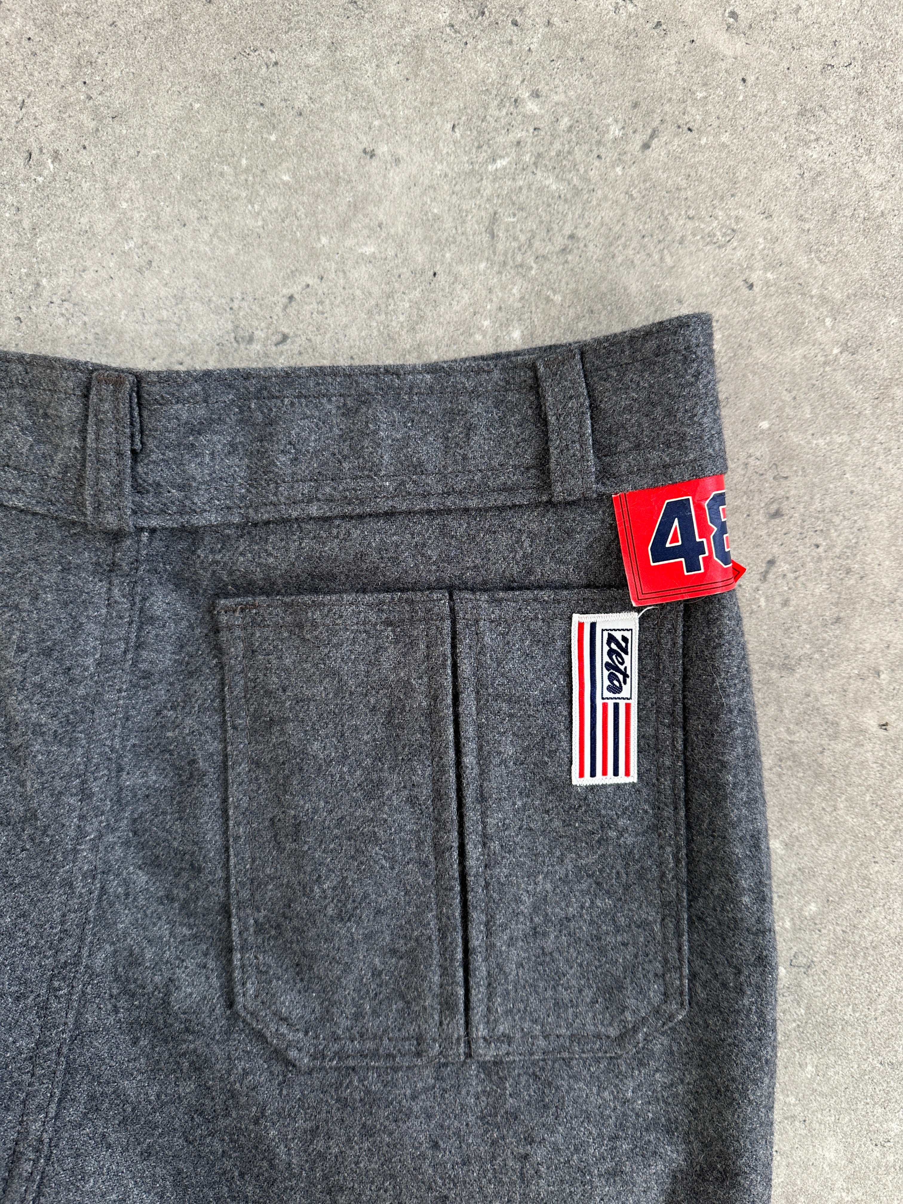 Italian vintage 1970s wool flared tailored trousers, size W28, with classic high-waisted design and wide-leg silhouette.