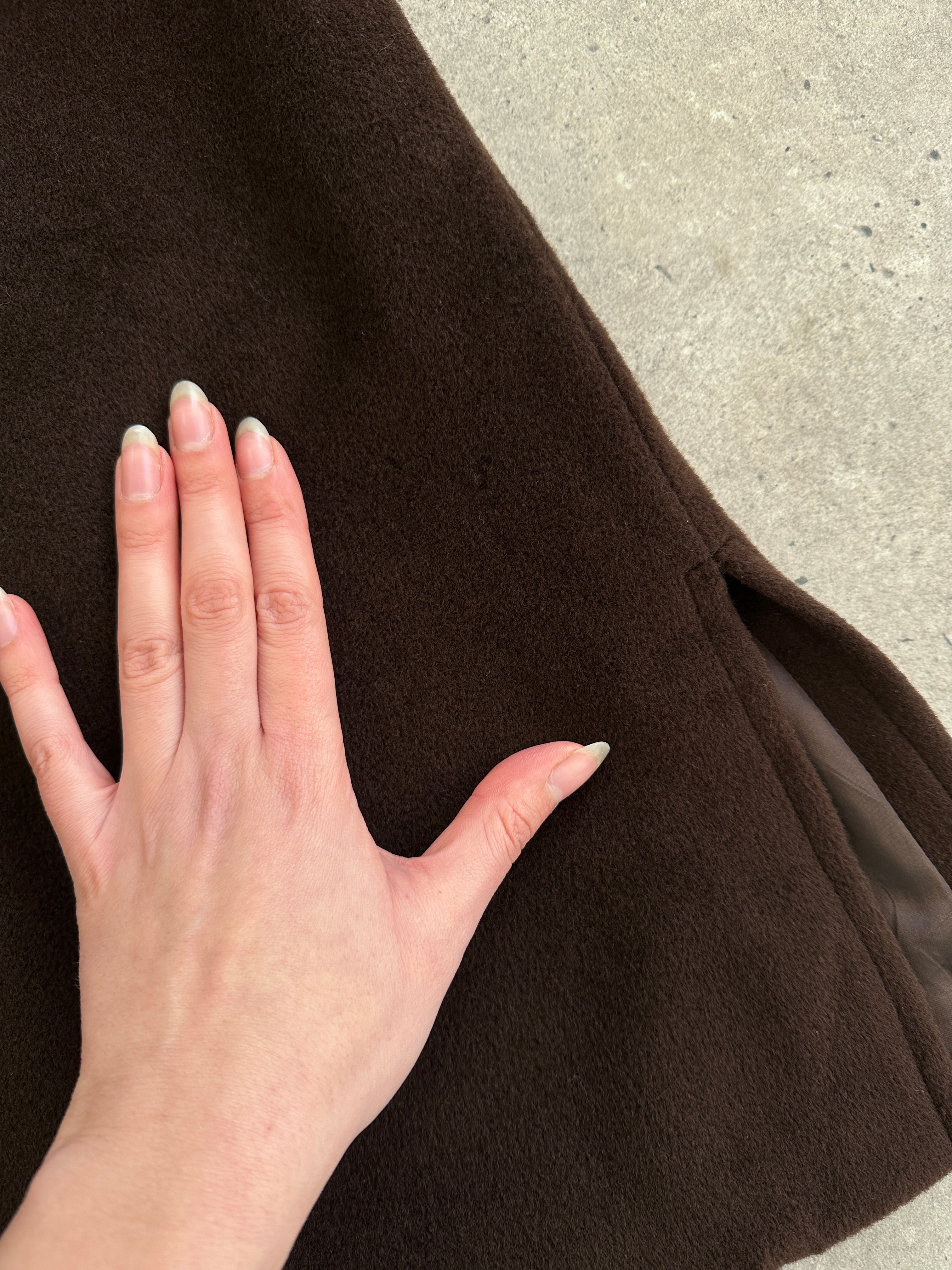 Max Mara pure virgin wool A-line coat in XL displayed on a hanger, showcasing its classic design and tailored fit.