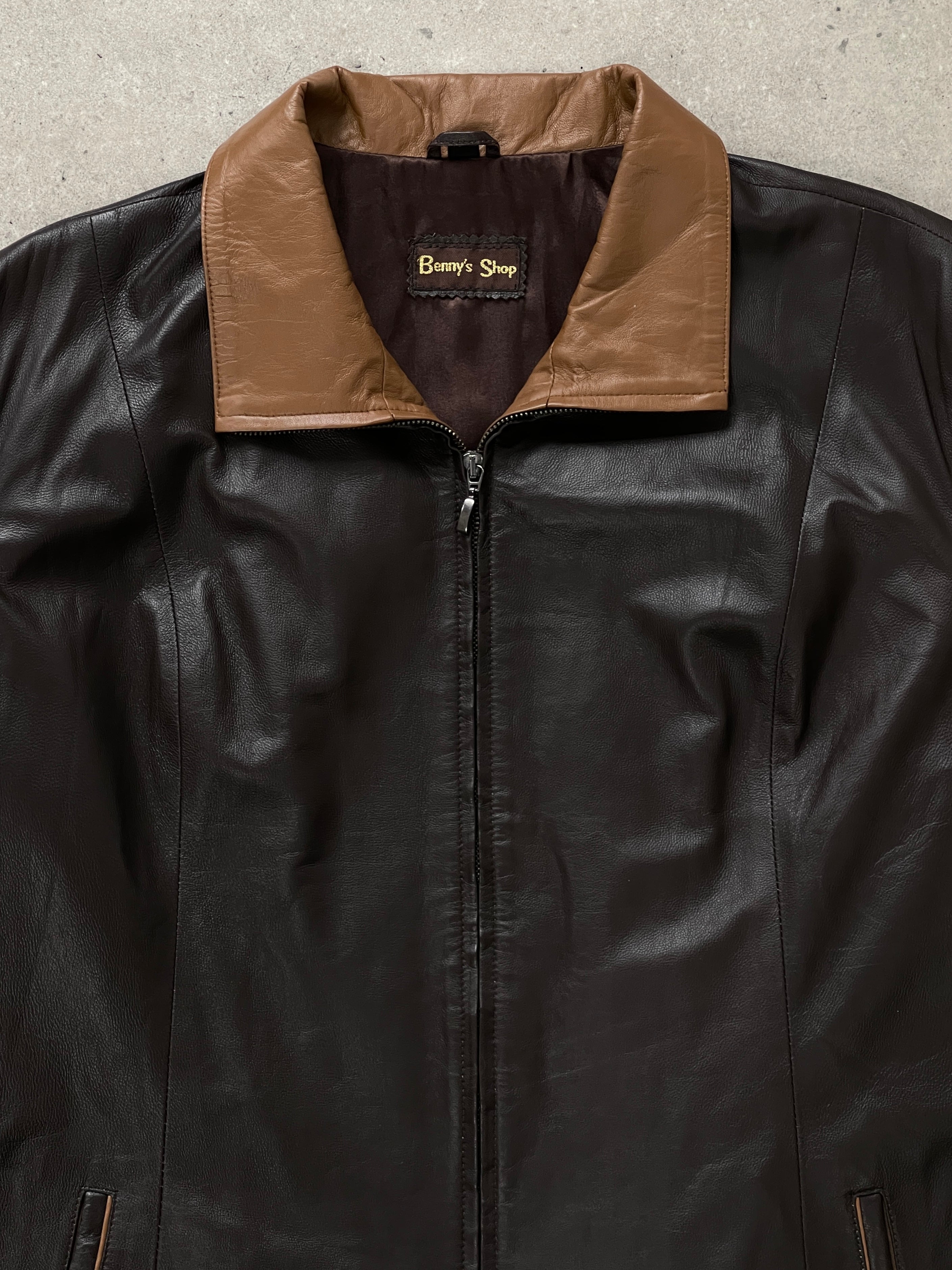 Vintage 1990s high neck leather jacket in black with contrast panels, displayed on a hanger, size XL.