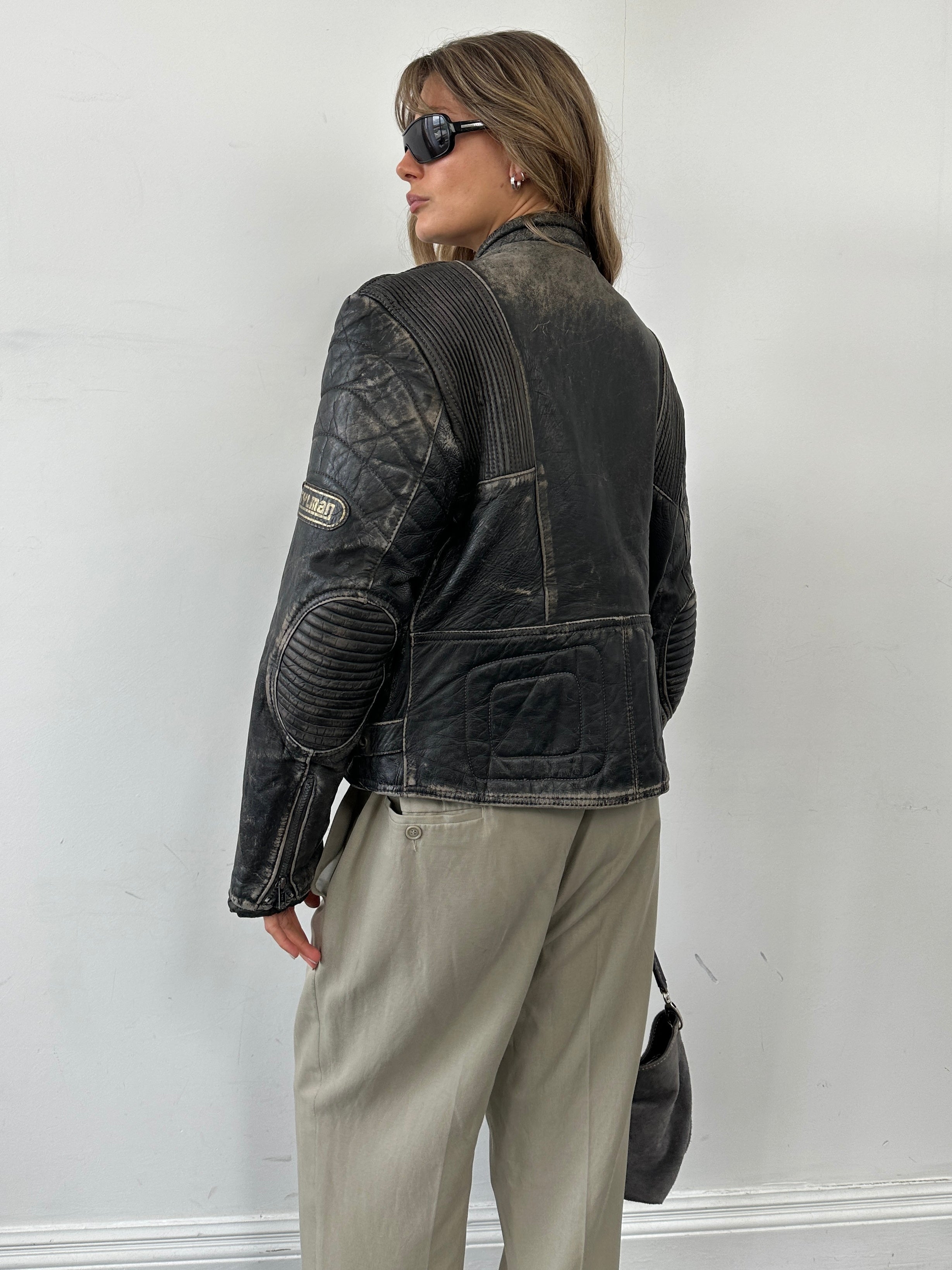 Vintage brand vintage motorcycle distressed leather jacket in size M/L, featuring rugged, worn-in leather with classic motorcycle style.