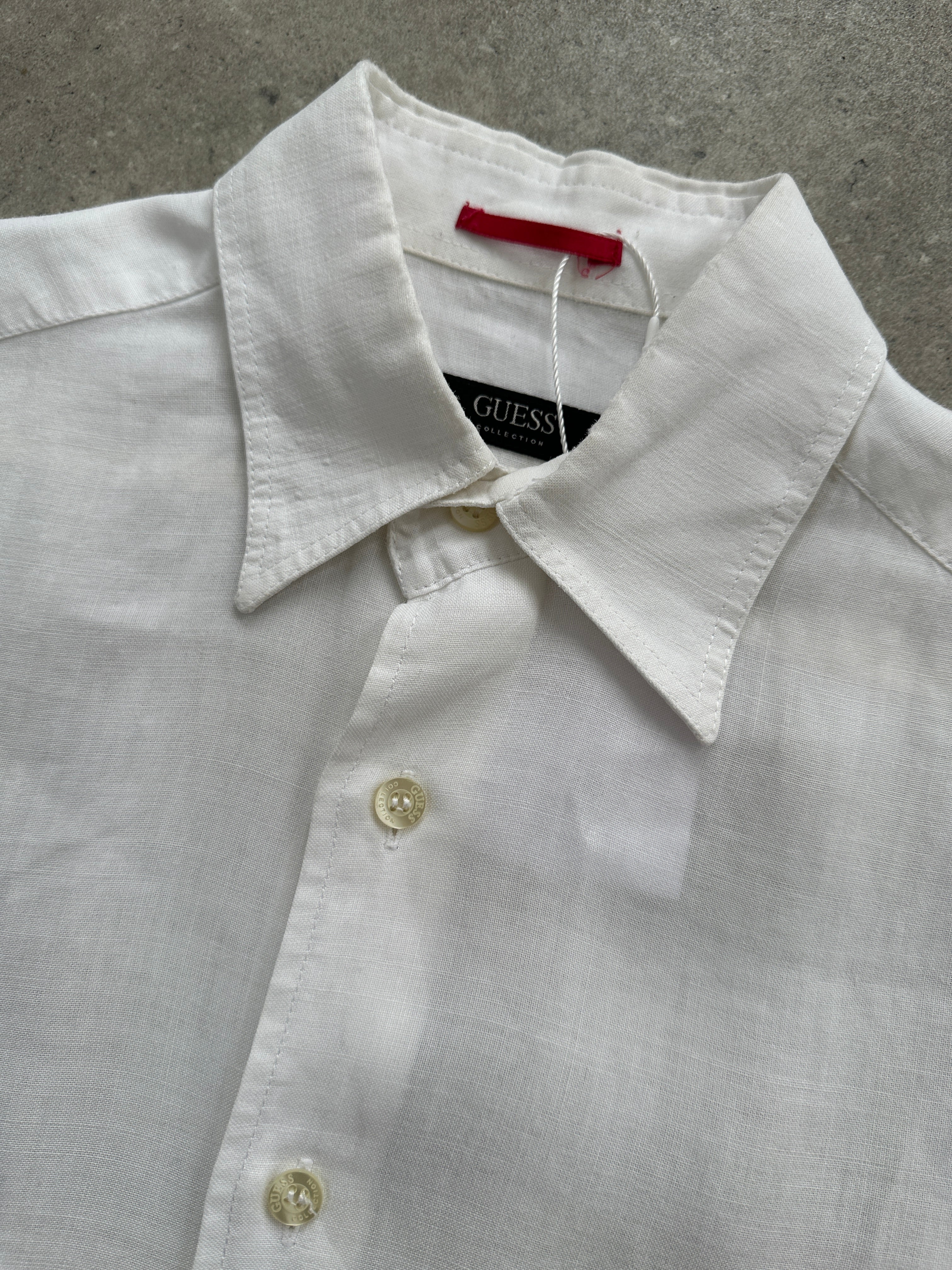 Guess Pure Linen Sheer Short Sleeve Shirt in white, lightweight and breathable with a relaxed fit, displayed on a hanger.