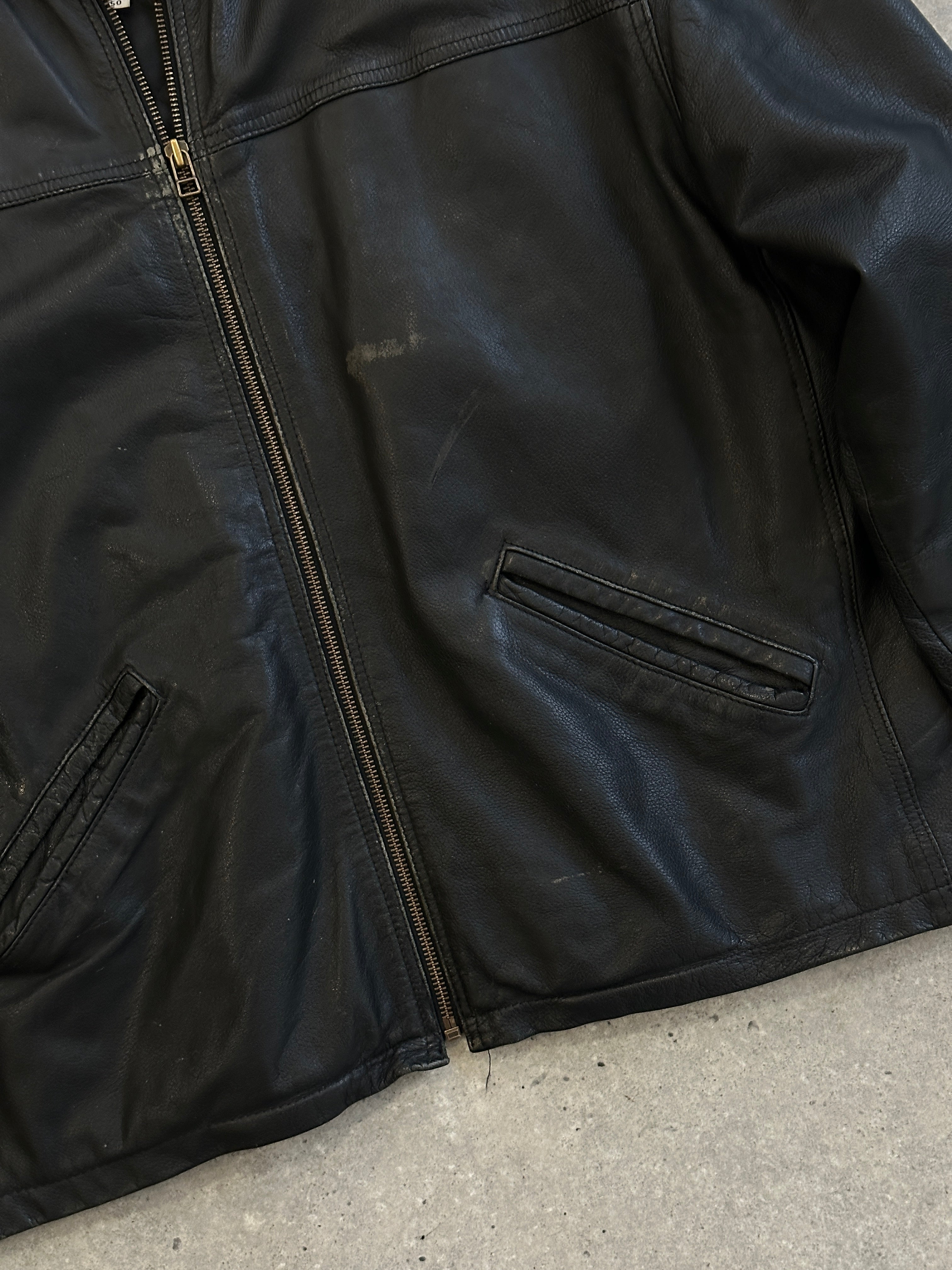 Vintage Italian leather jacket in boxy style, showing front view with classic collar and textured leather in size M/L.