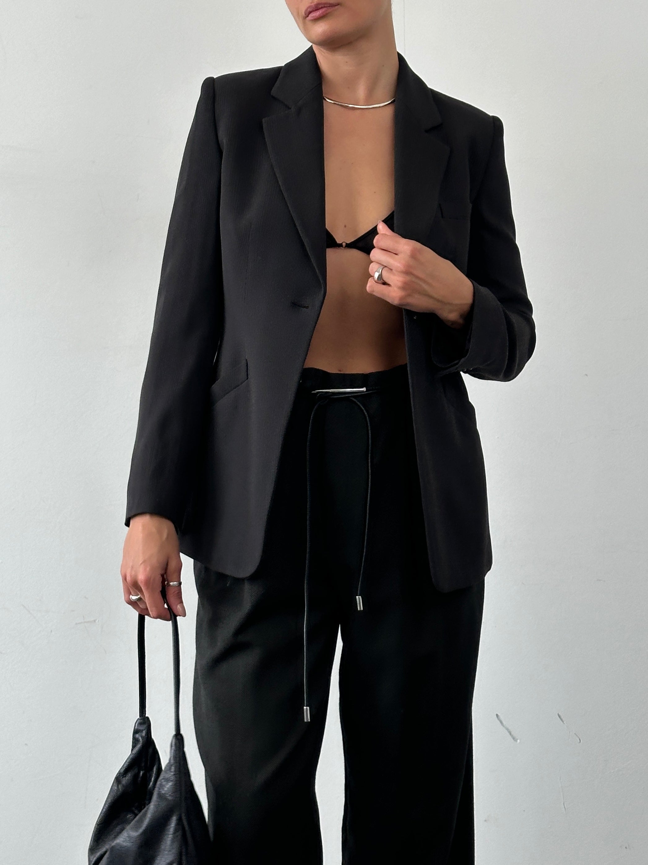 Armani Collezioni fitted single-button blazer in dark fabric, tailored style with notch lapel and sleek design.