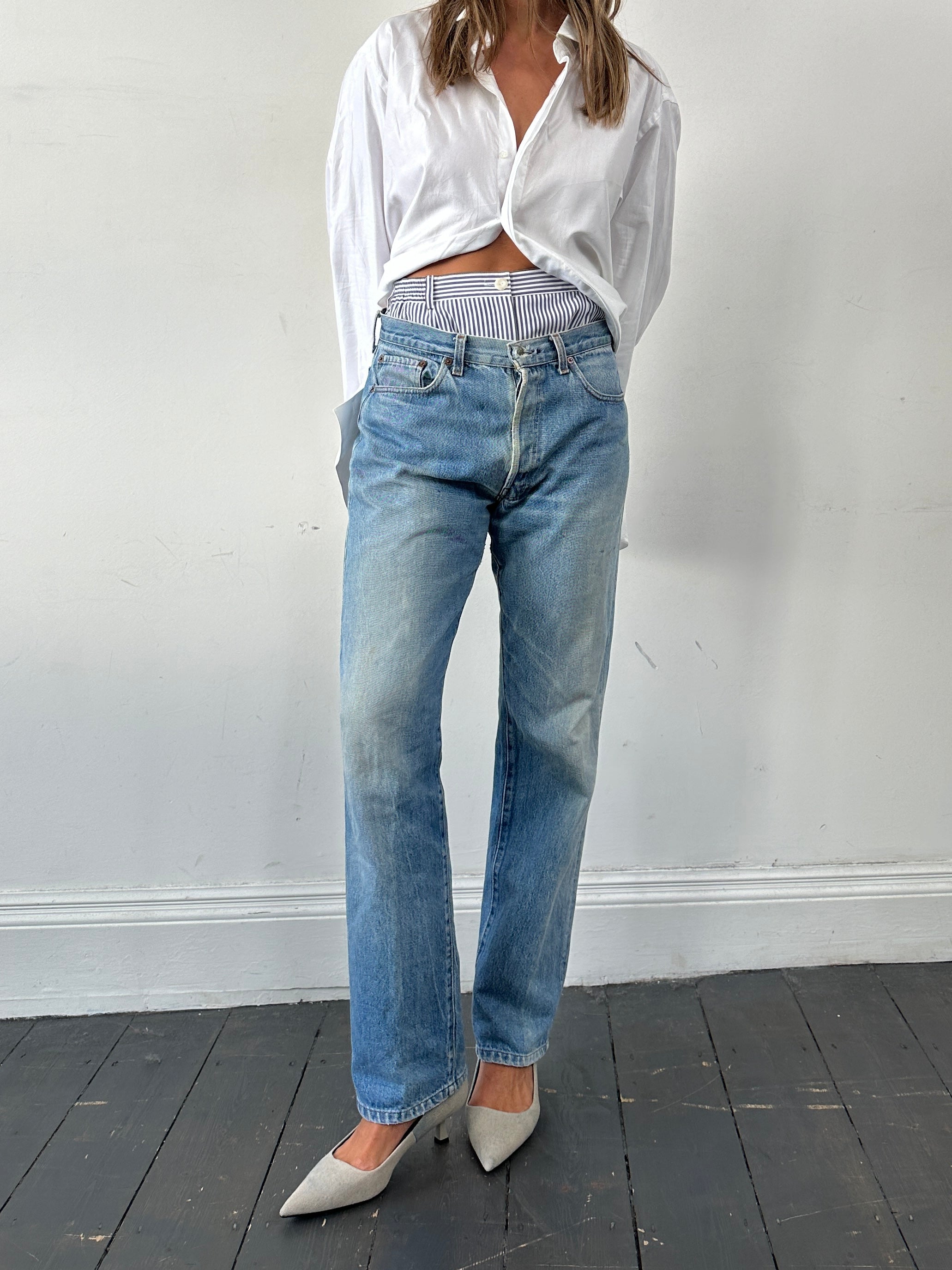 Levi’s 501 straight leg denim jeans in W32, front view showing classic blue wash and traditional five-pocket design.
