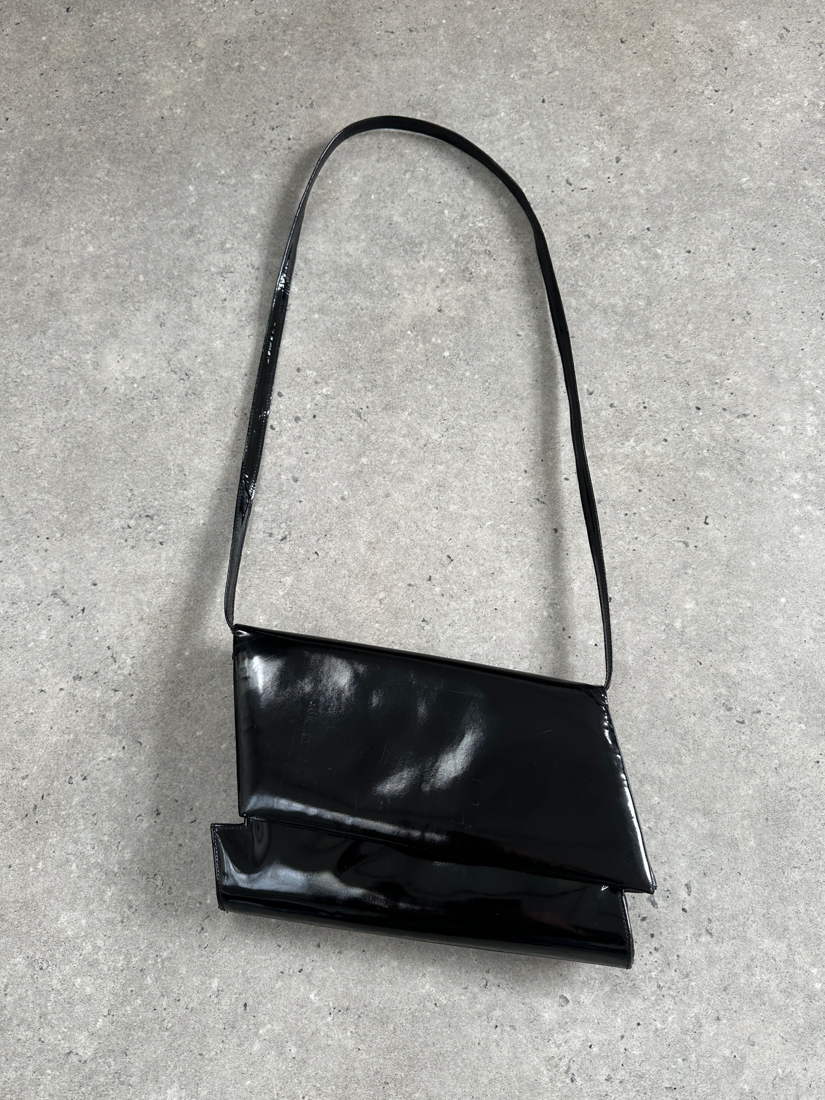 Charles Jourdan 1990s asymmetric patent crossbody bag with sleek design and bold geometric shape.