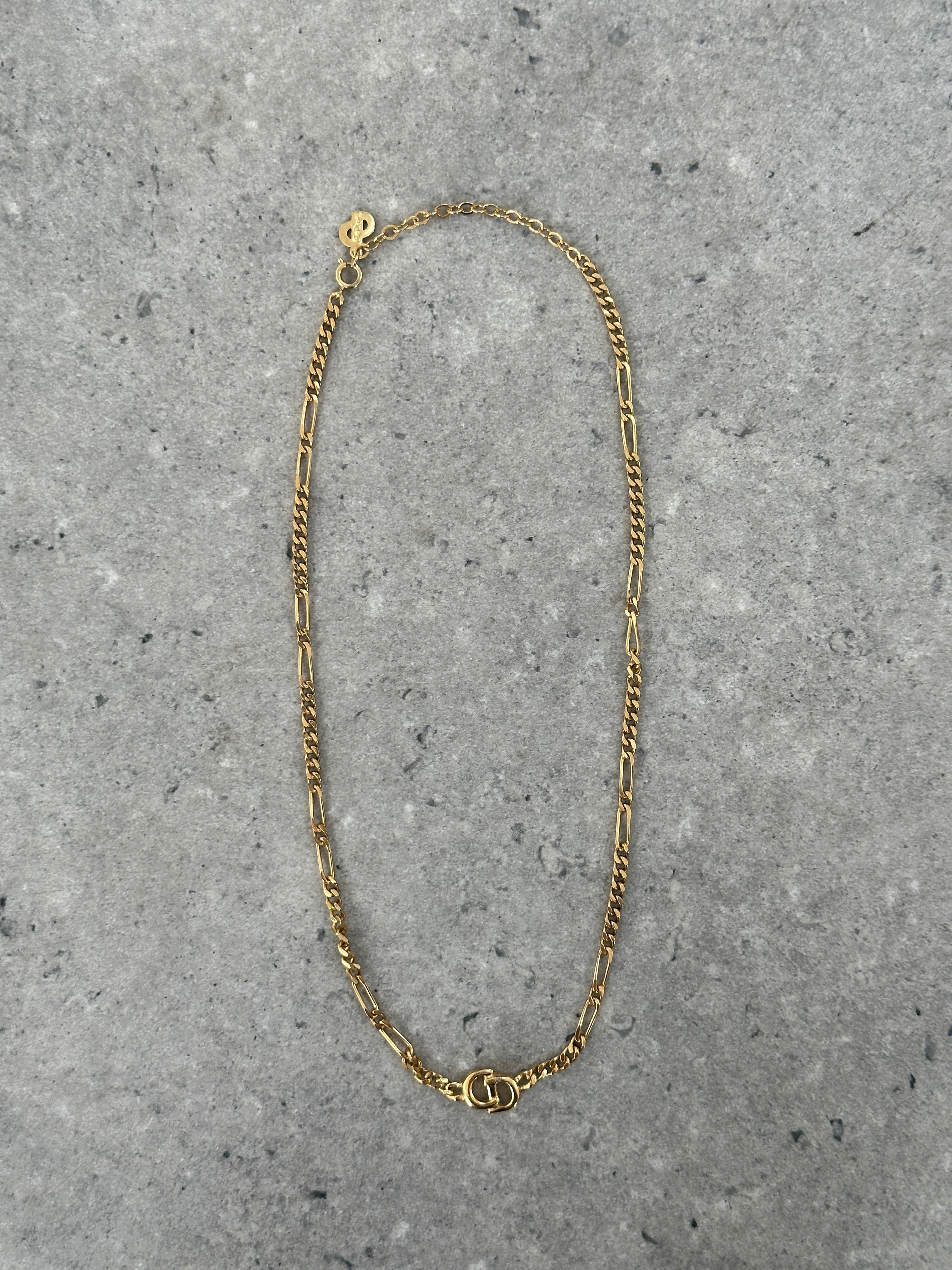 Christian Dior 18-inch gold-plated logo pendant necklace featuring a sleek, elegant design with a prominent Dior logo charm.