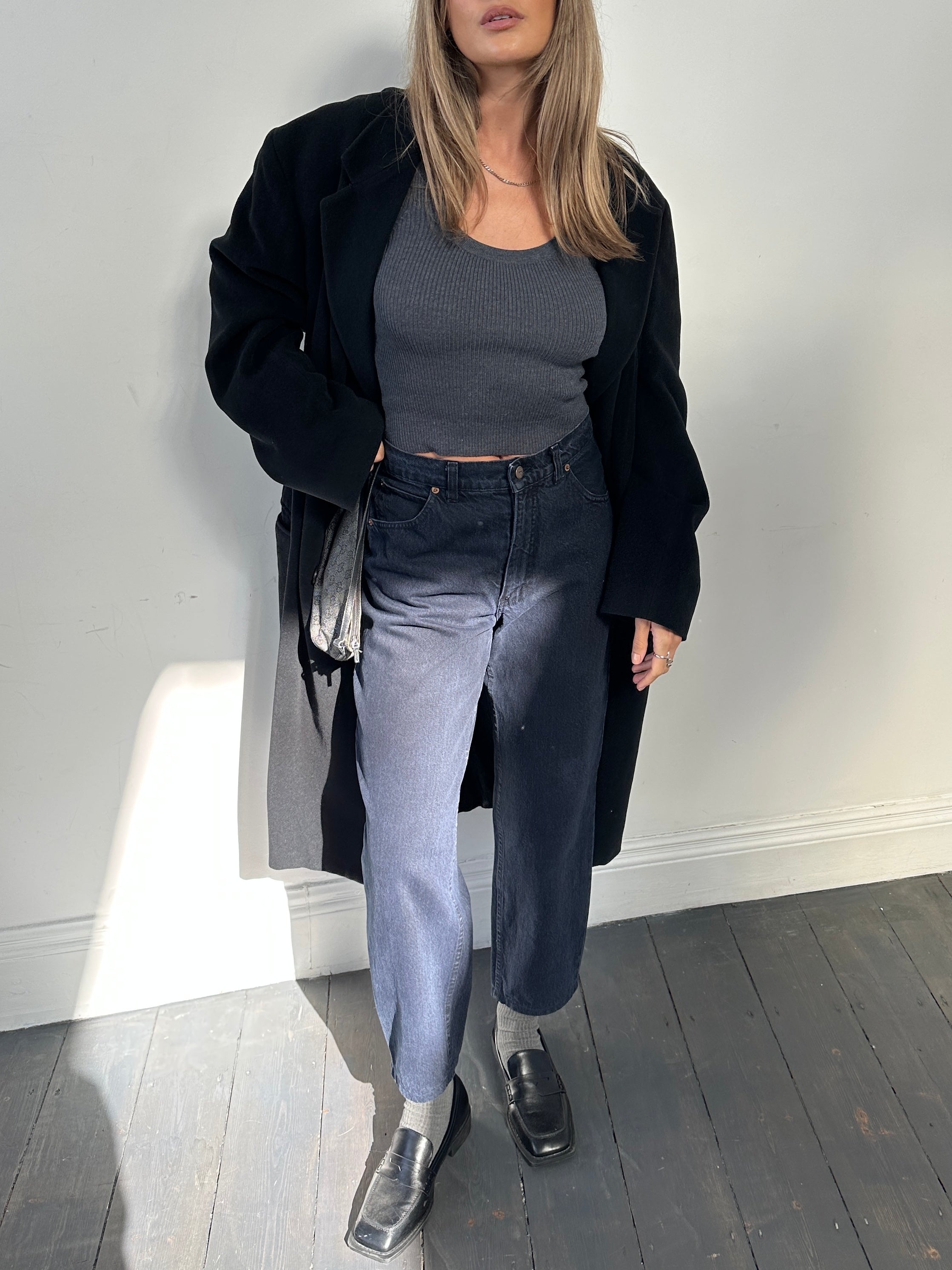 Valentino tapered high-waisted denim jeans in W28, featuring a classic blue wash and tailored fit, displayed on a model.