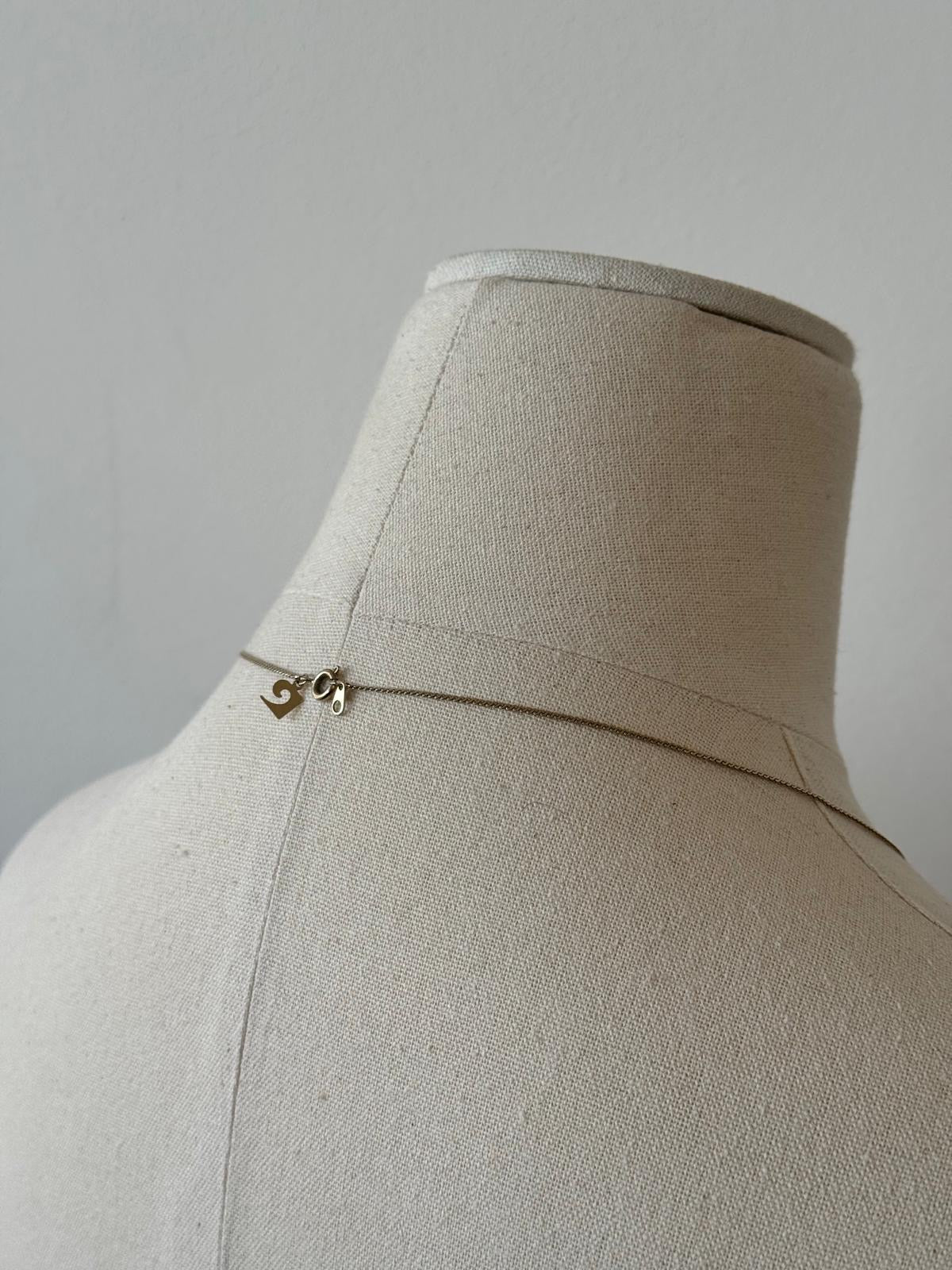 Pierre Cardin 1990s gold plated fine necklace with delicate chain and subtle elegant design.